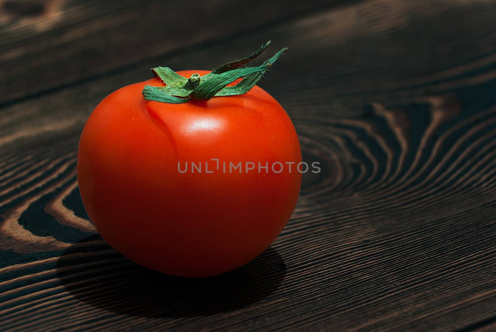 Ripe Red Tomatoes on a Wooden Table with Black Background. Dark Rustic Old Style
