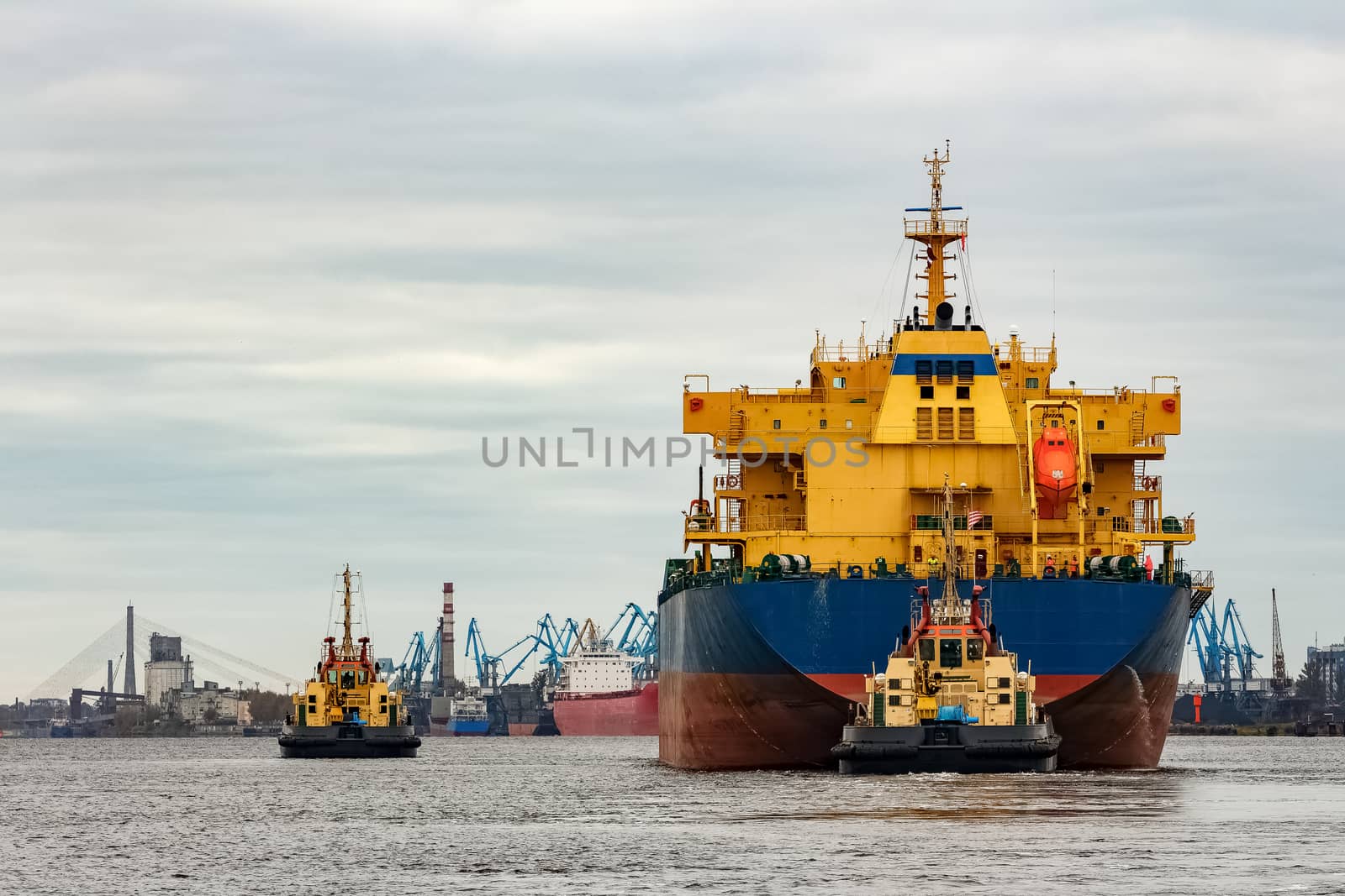Blue cargo ship entering the port of Riga, Europe