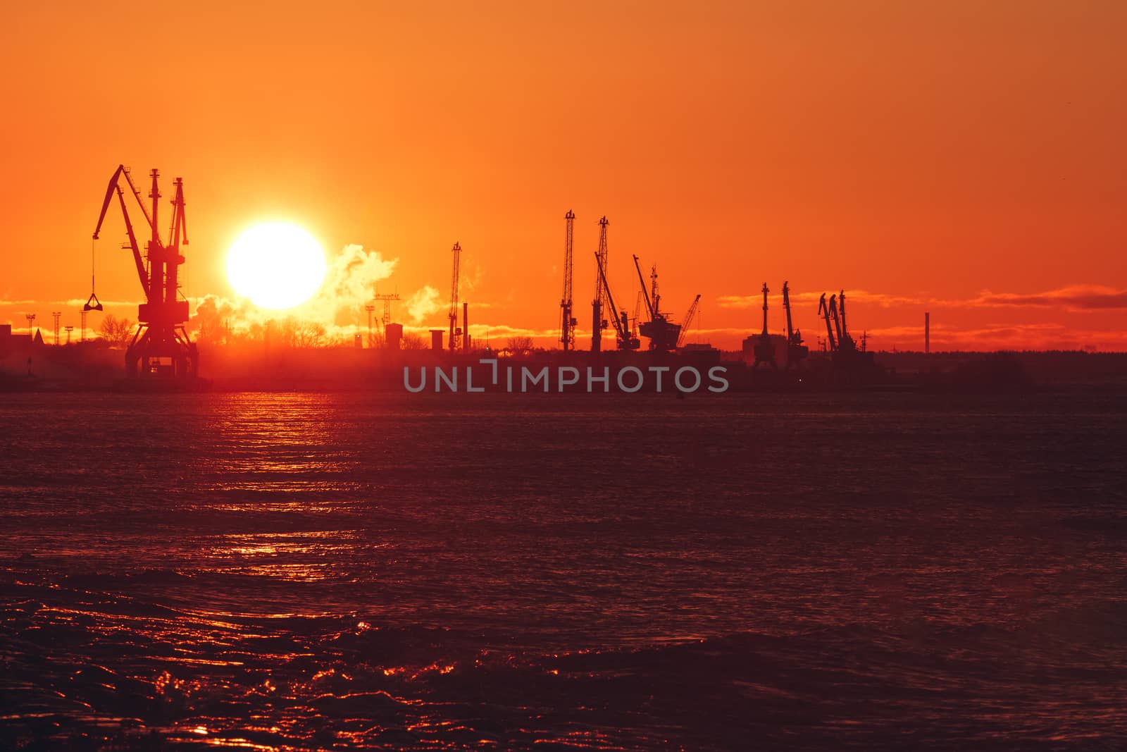 Hot winter sunrise over the cargo port in Riga