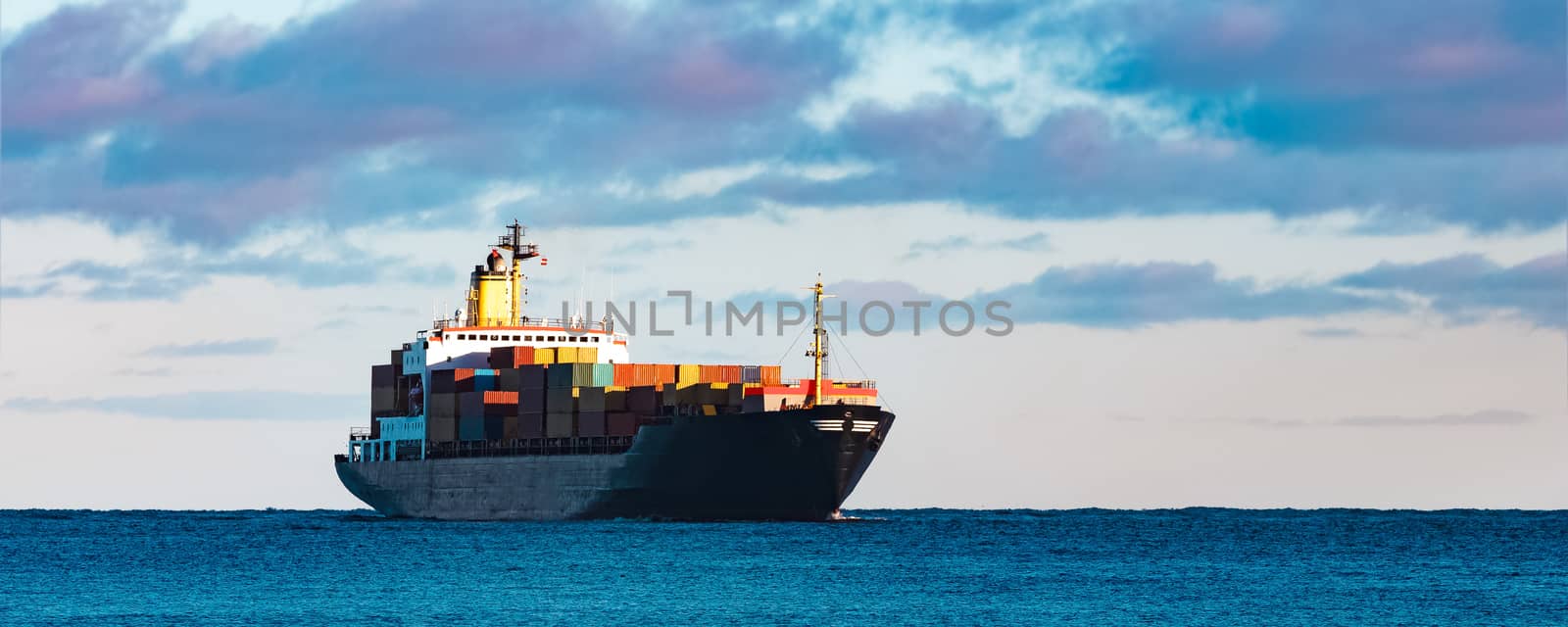 Modern black container ship moving from Baltic sea