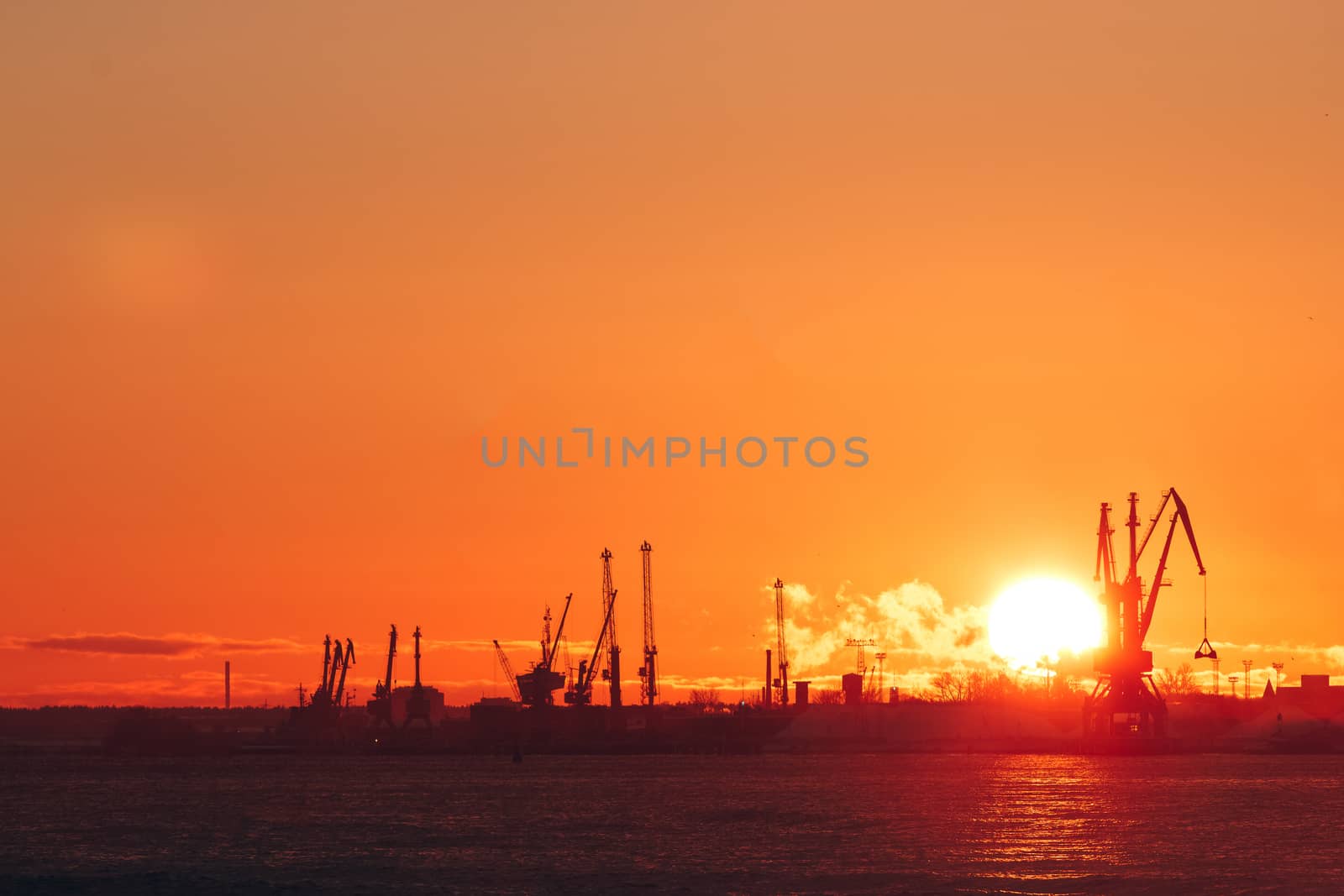 Hot winter sunrise over the cargo port in Riga