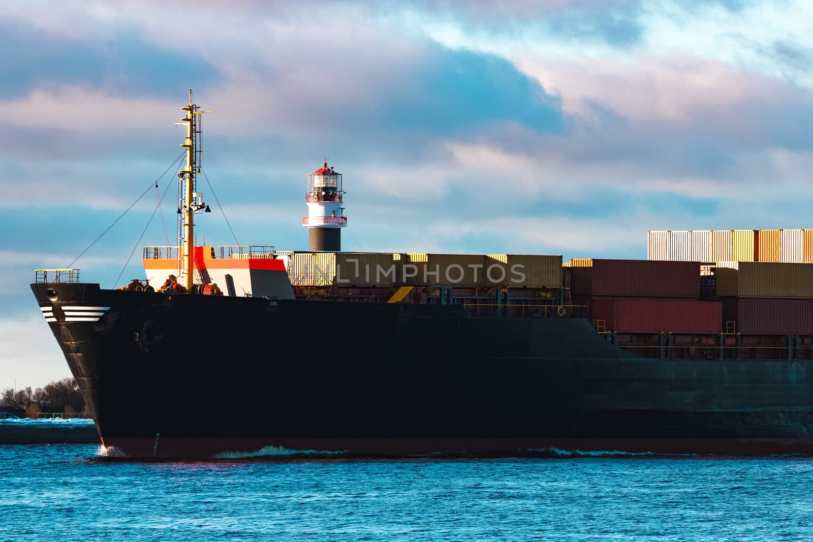 Modern black container ship moving from Baltic sea