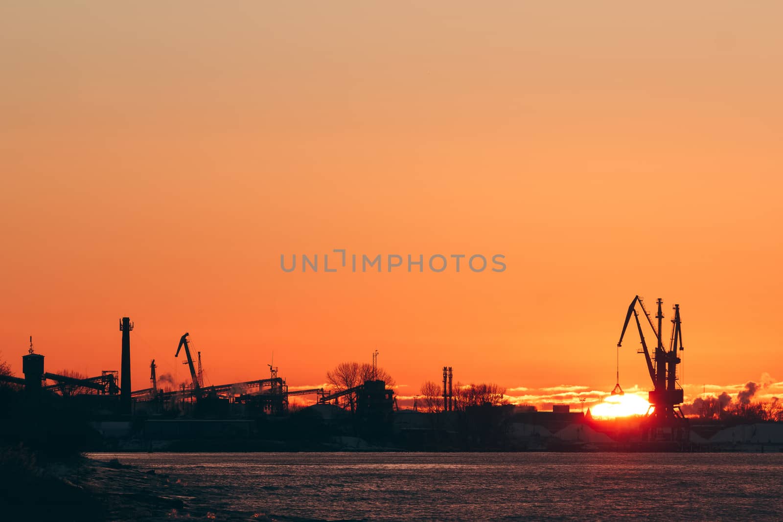 Hot winter sunrise over the cargo port in Riga