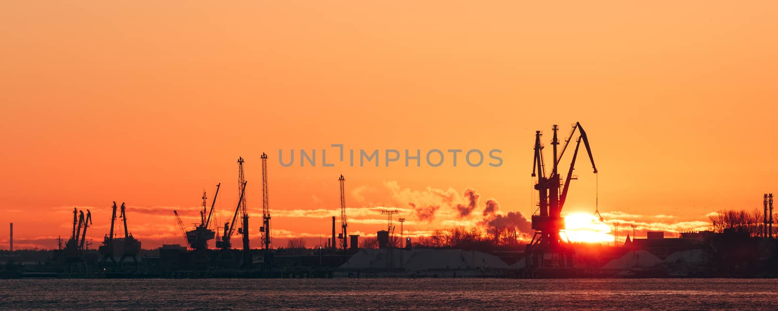 Hot winter sunrise over the cargo port in Riga