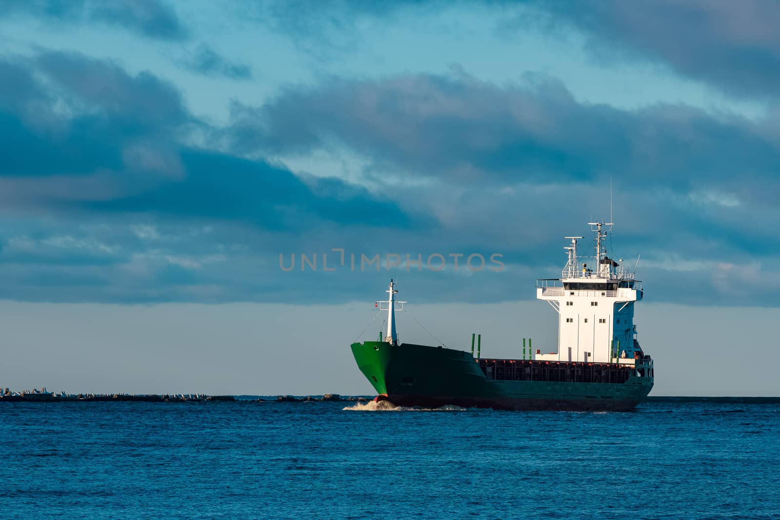 Green bulk carrier sailing from the Baltic sea