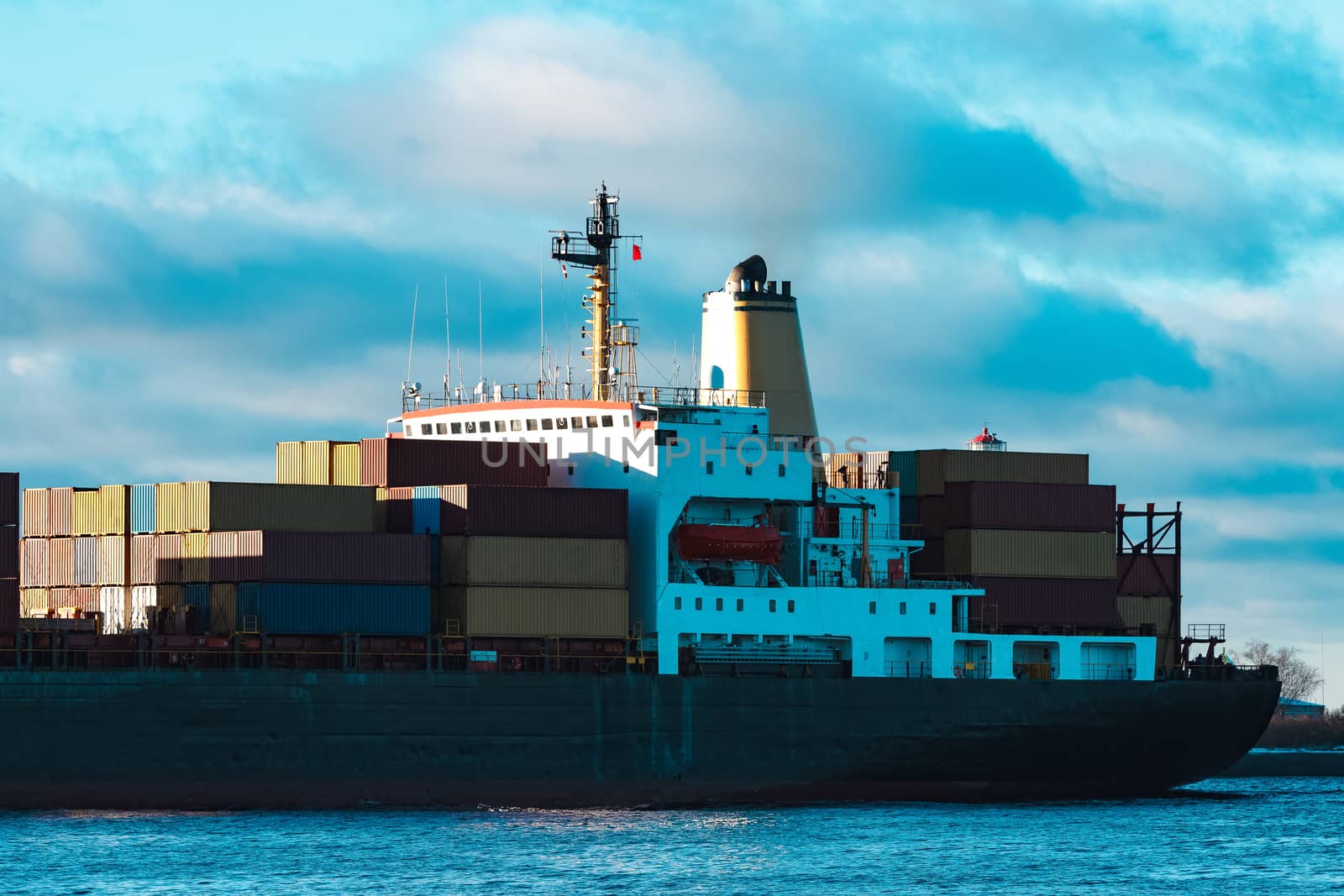 Modern black container ship moving from Baltic sea