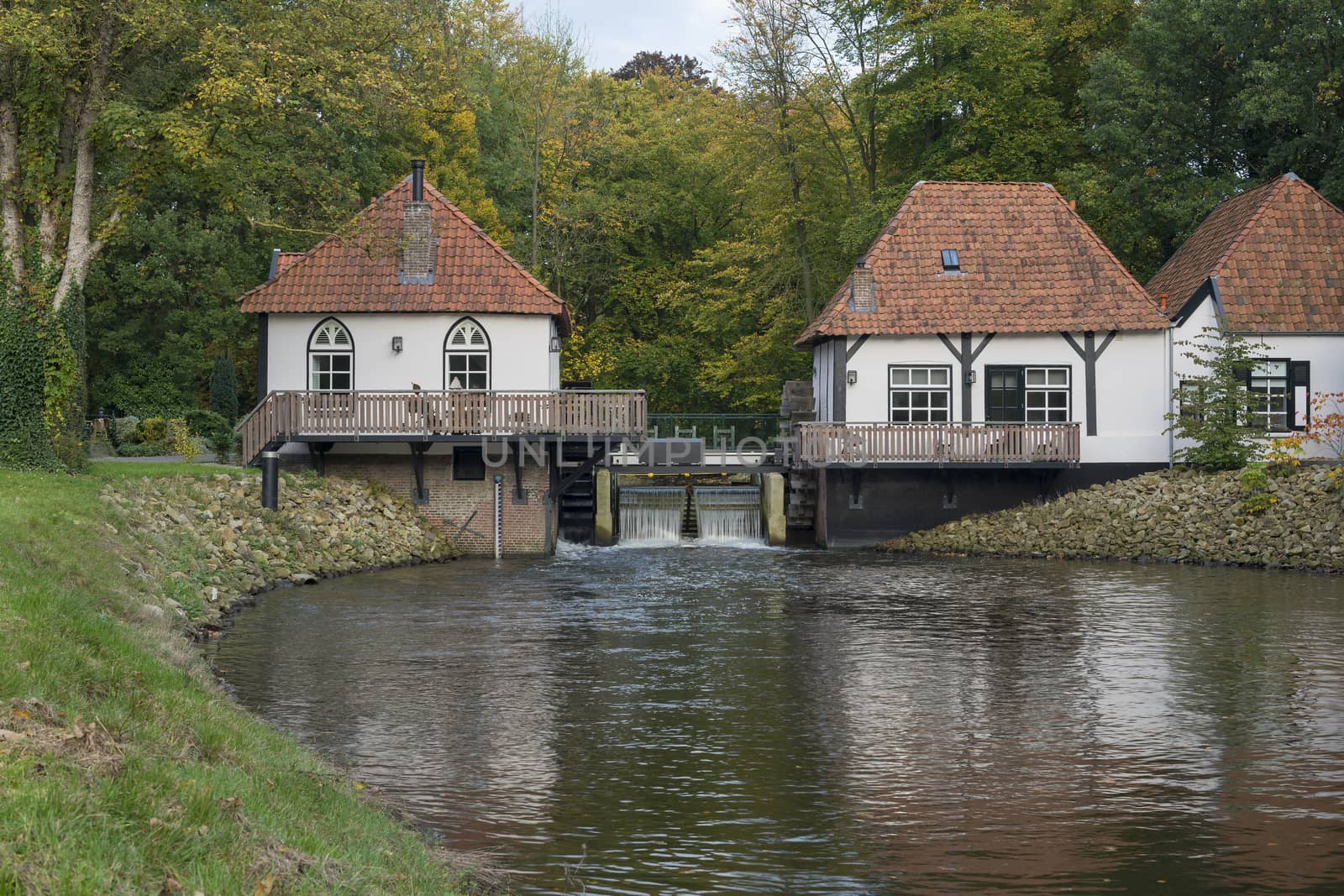 The recently restored historic water mill called The Olliemölle or Den Helder in the stream of the river the Boven-Slinge in Winterswijk in Hamlet the Achterhoek in the Netherlands. The water mill is a national monument and the restoration is completed in 2016.
