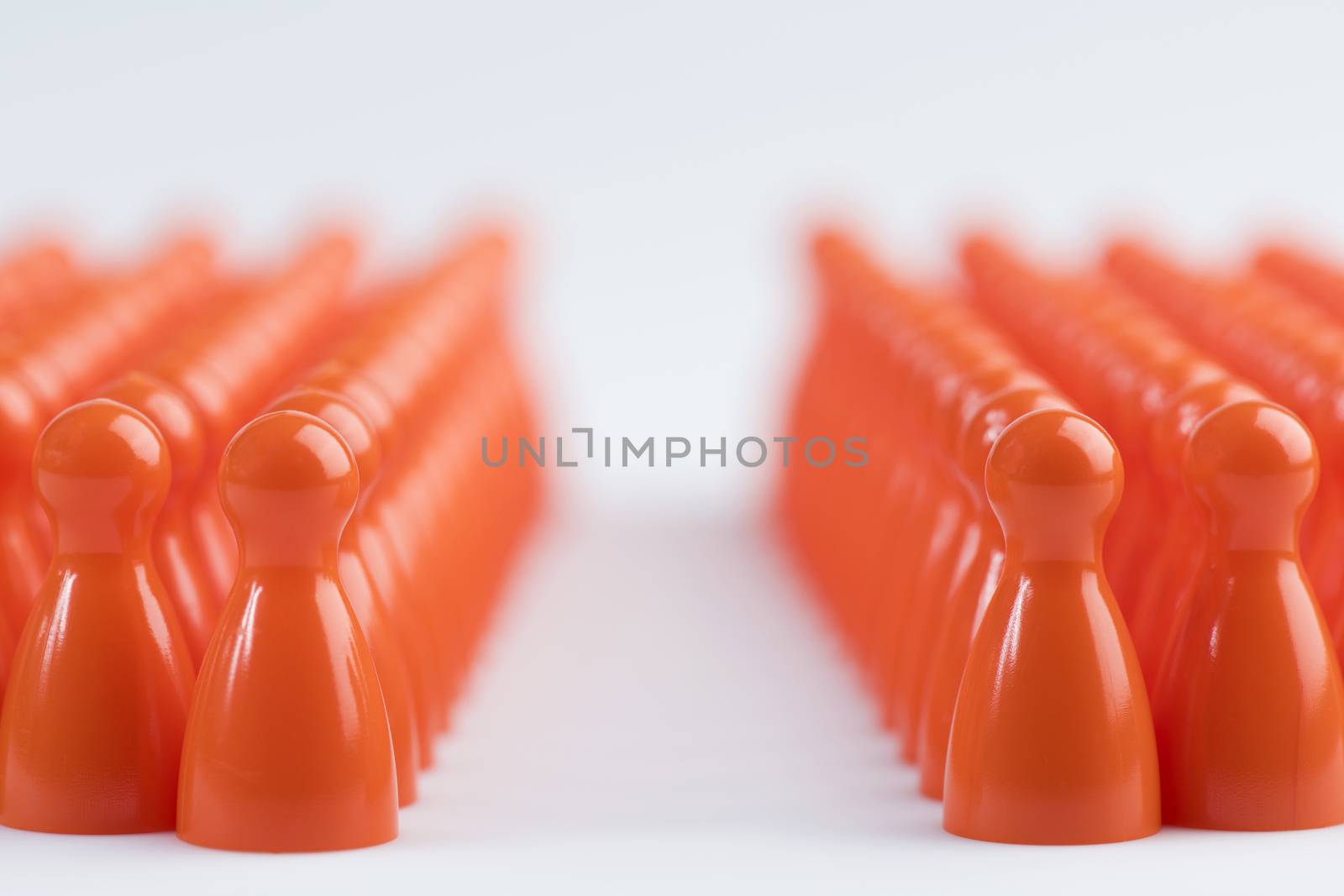 Conceptual orange game pawns as abstract view of a crowd
