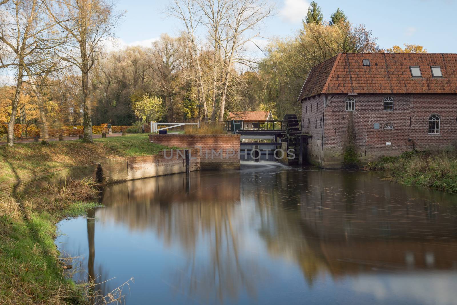The restored historic water mill called Berenschot in the stream of the river the Boven-Slinge in Winterswijk in Hamlet the Achterhoek in the Netherlands.

