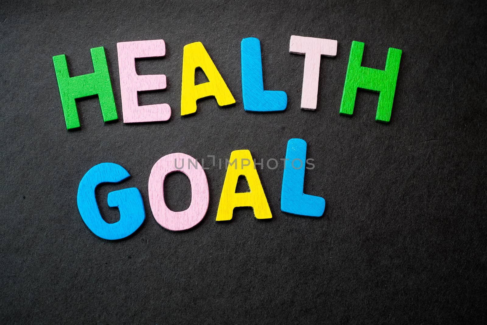 Colorful wooden letters forming the phrase "health goal"