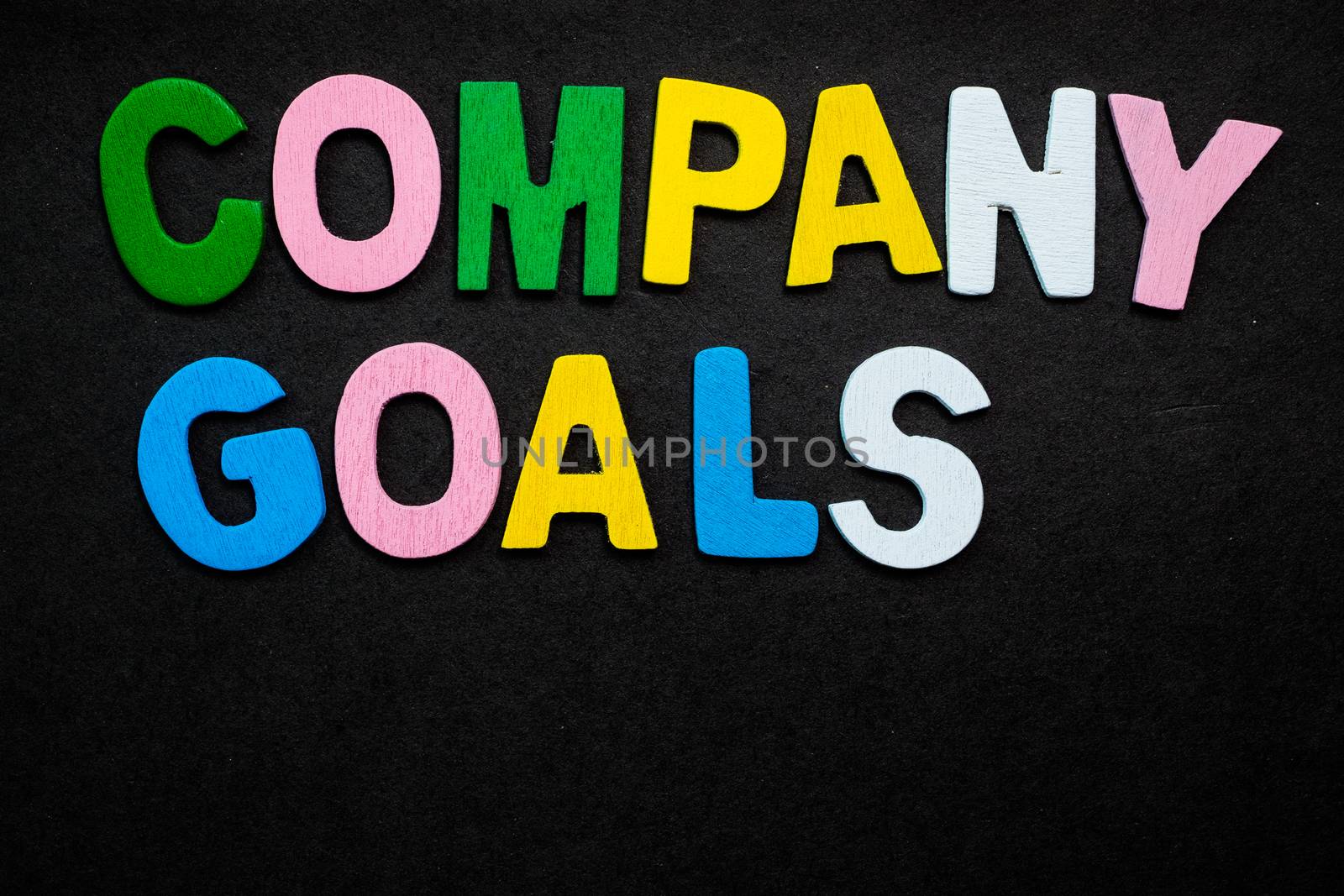 Colorful wooden letters forming the phrase "company goals"
