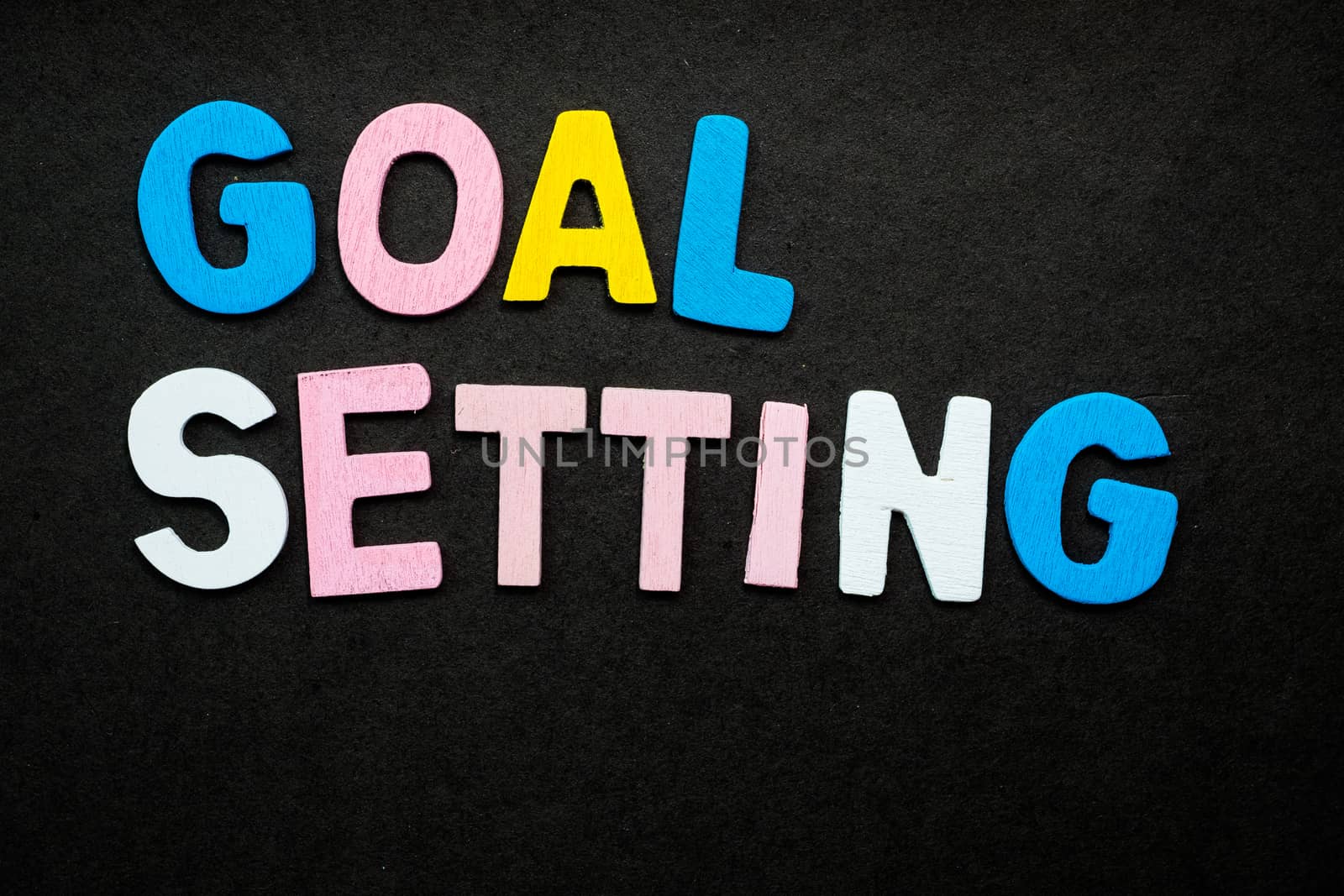 Colorful wooden letters forming the phrase "goal setting"