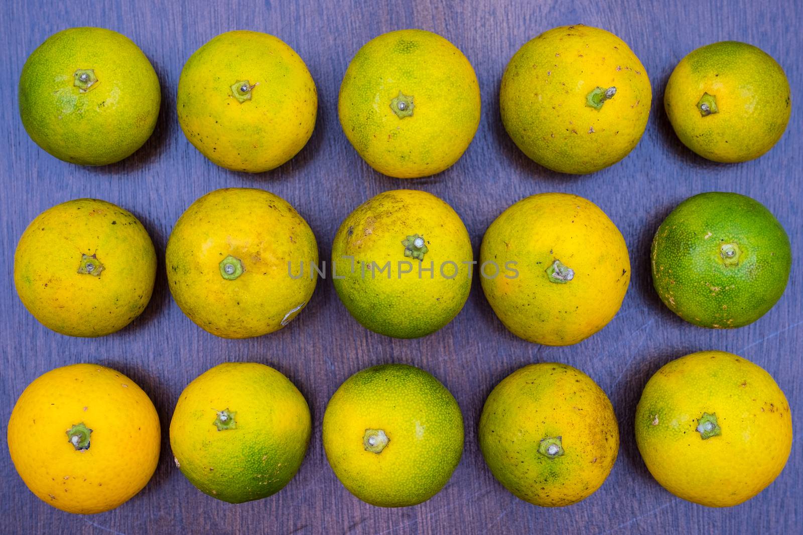 Overhead view of fresh limes arranged on a table top