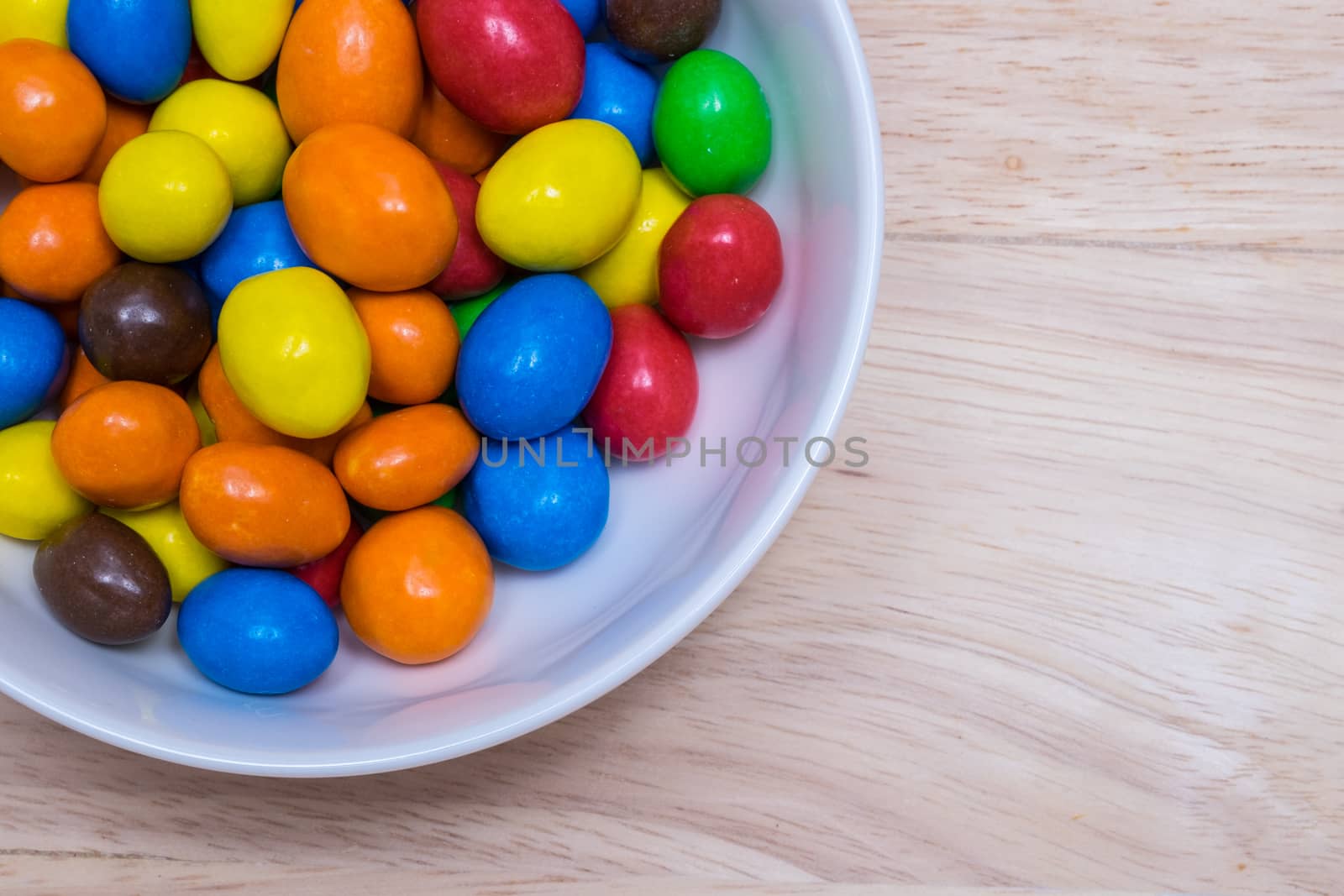 Colorful suger coated chocolate in a white bowl