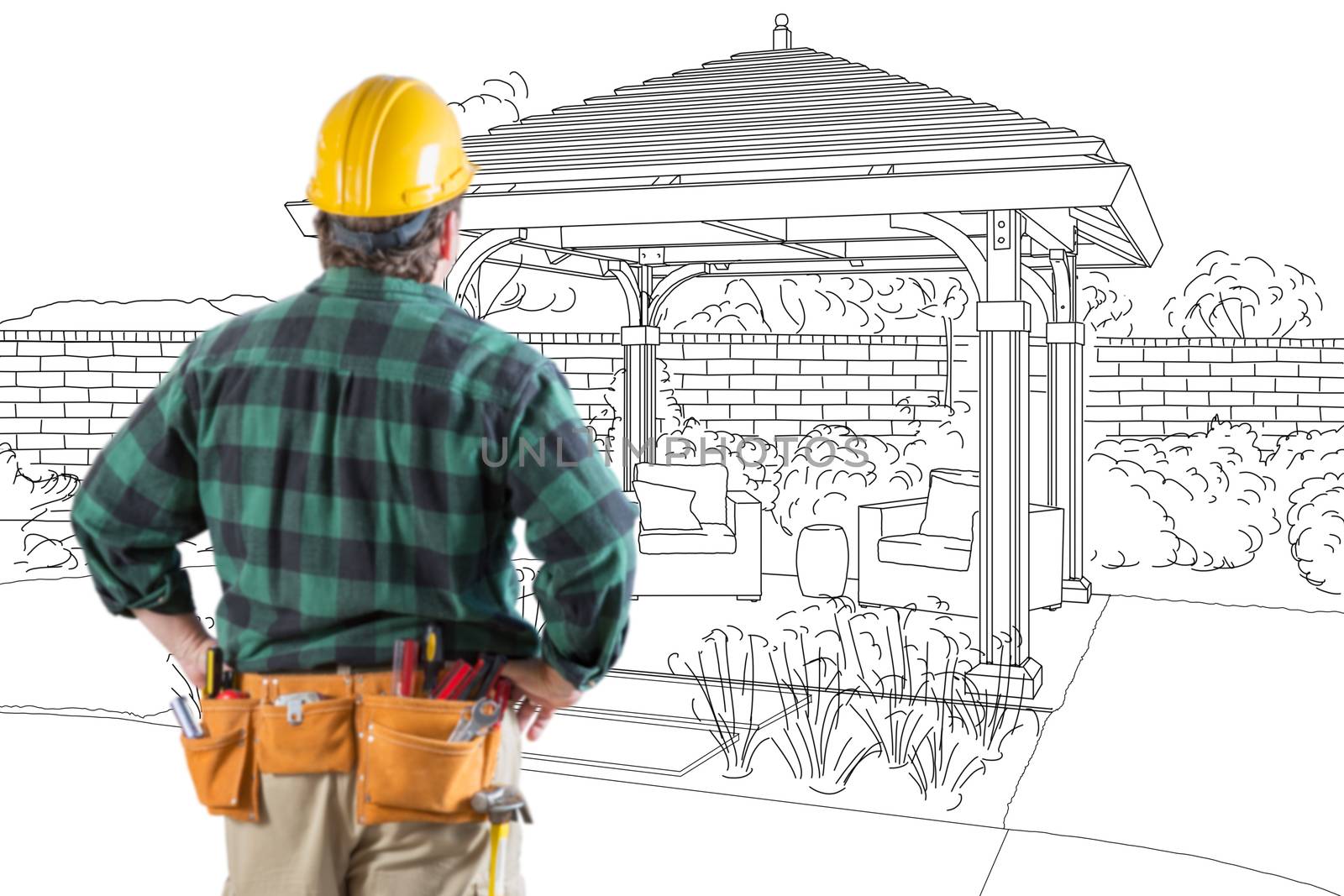 Contractor Standing Looking At Patio Pergola Design Drawing.