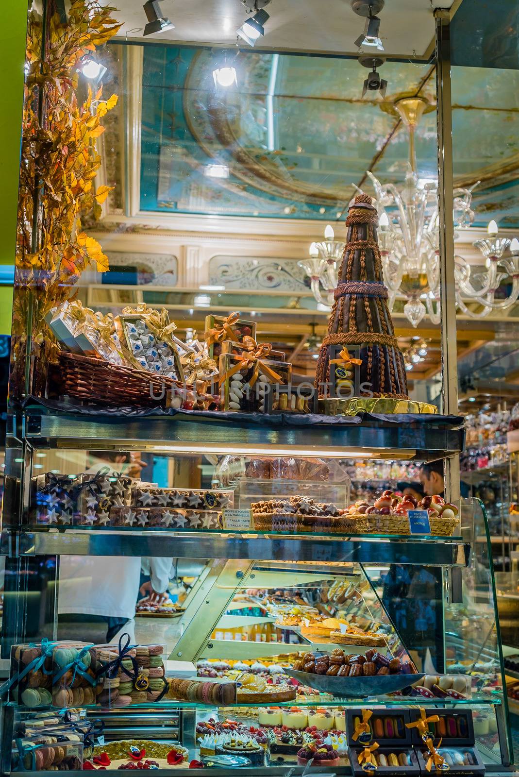 Sweets and chocolates in display window in Paris by night