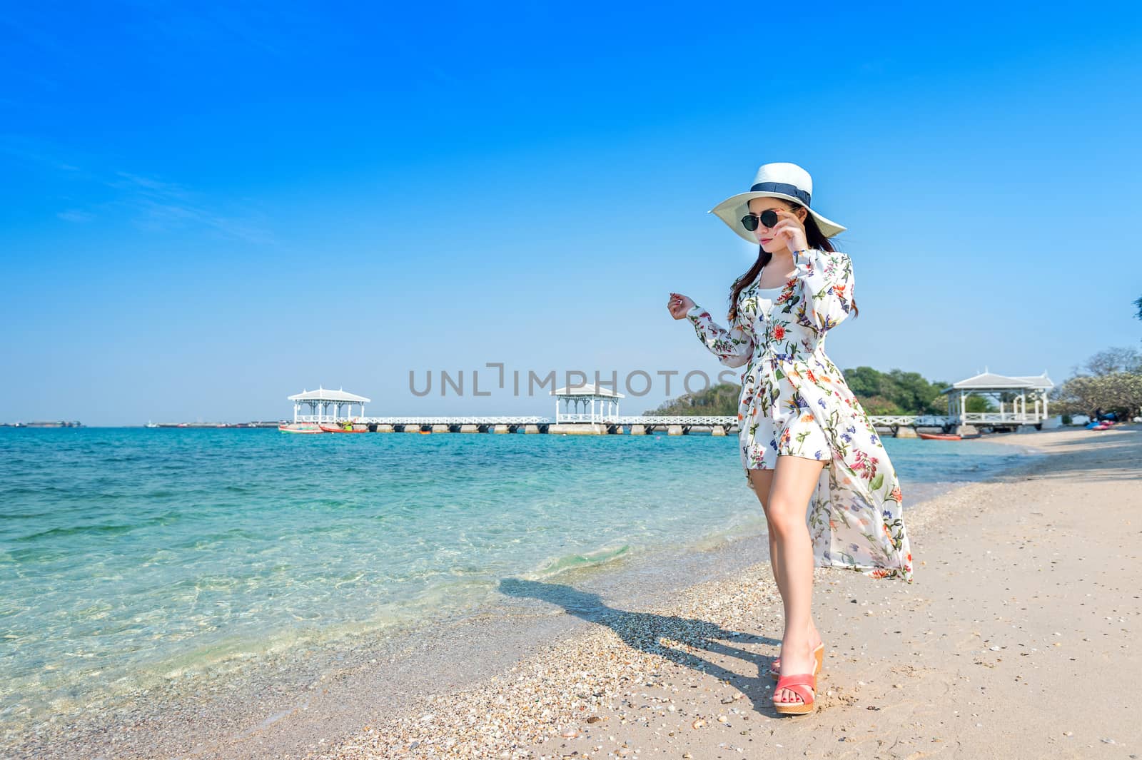 Young woman walking on beach in Si chang island, Thailand. by gutarphotoghaphy
