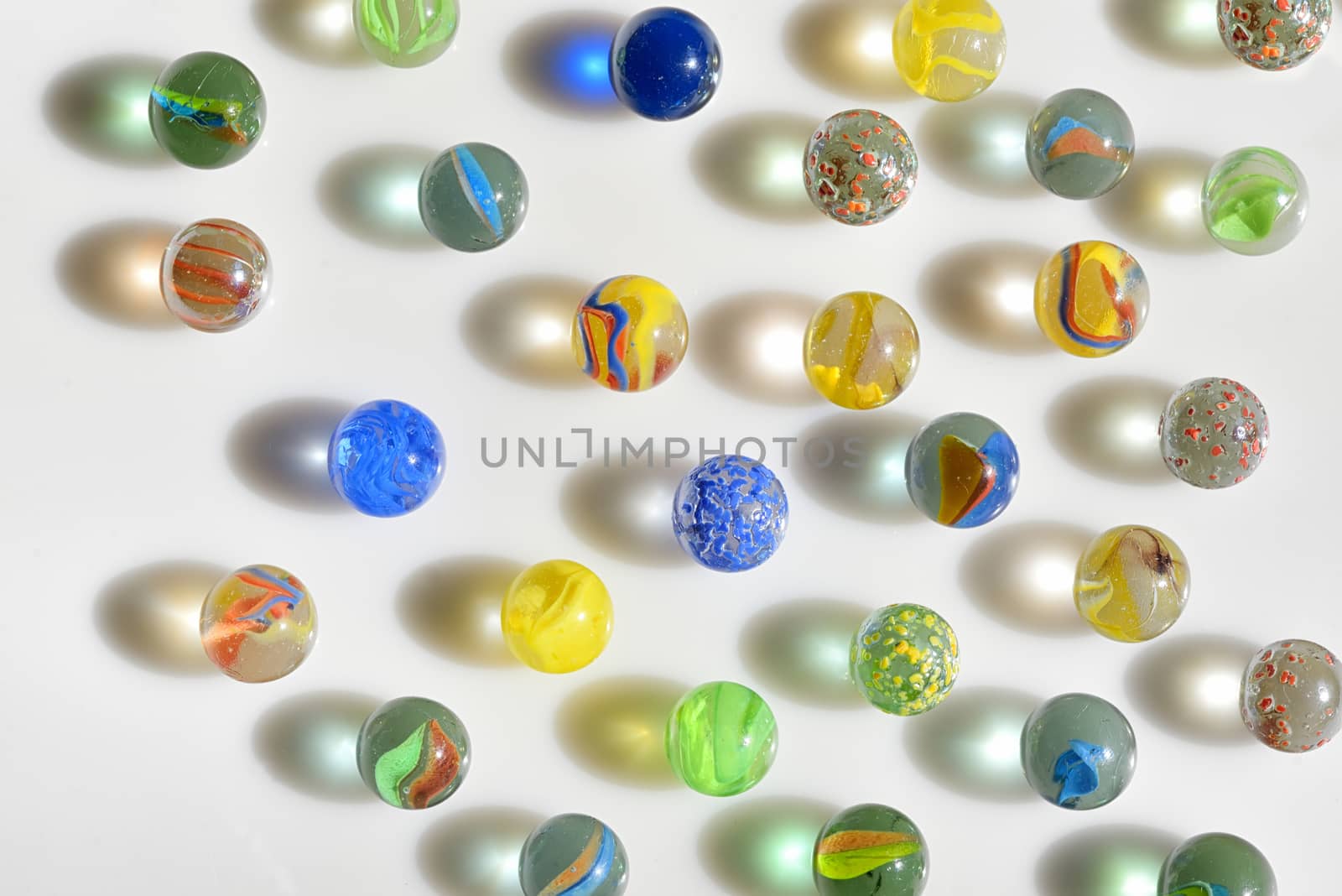 Colorfull glass marbles on white table