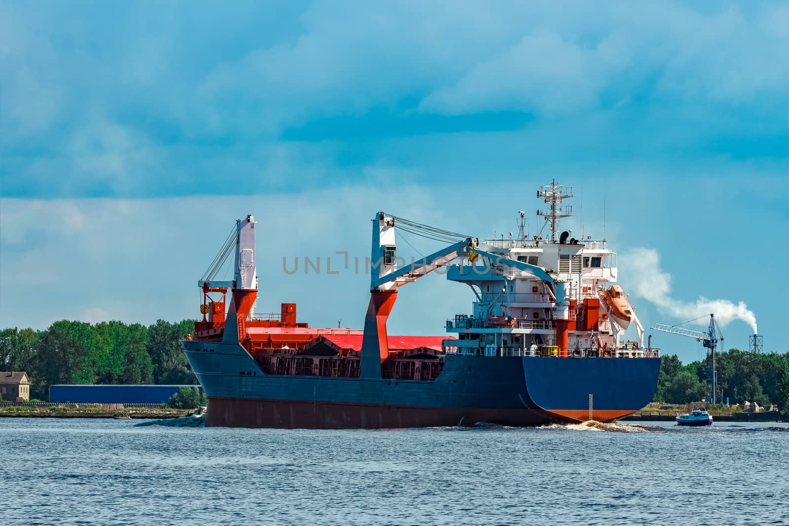 Blue cargo ship underway by sengnsp