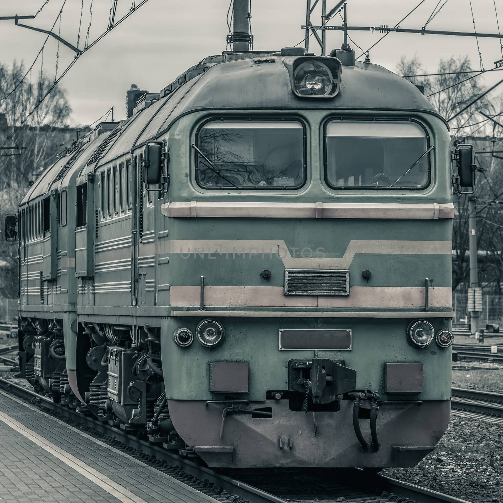 Old diesel cargo locomotive. Freight train in action