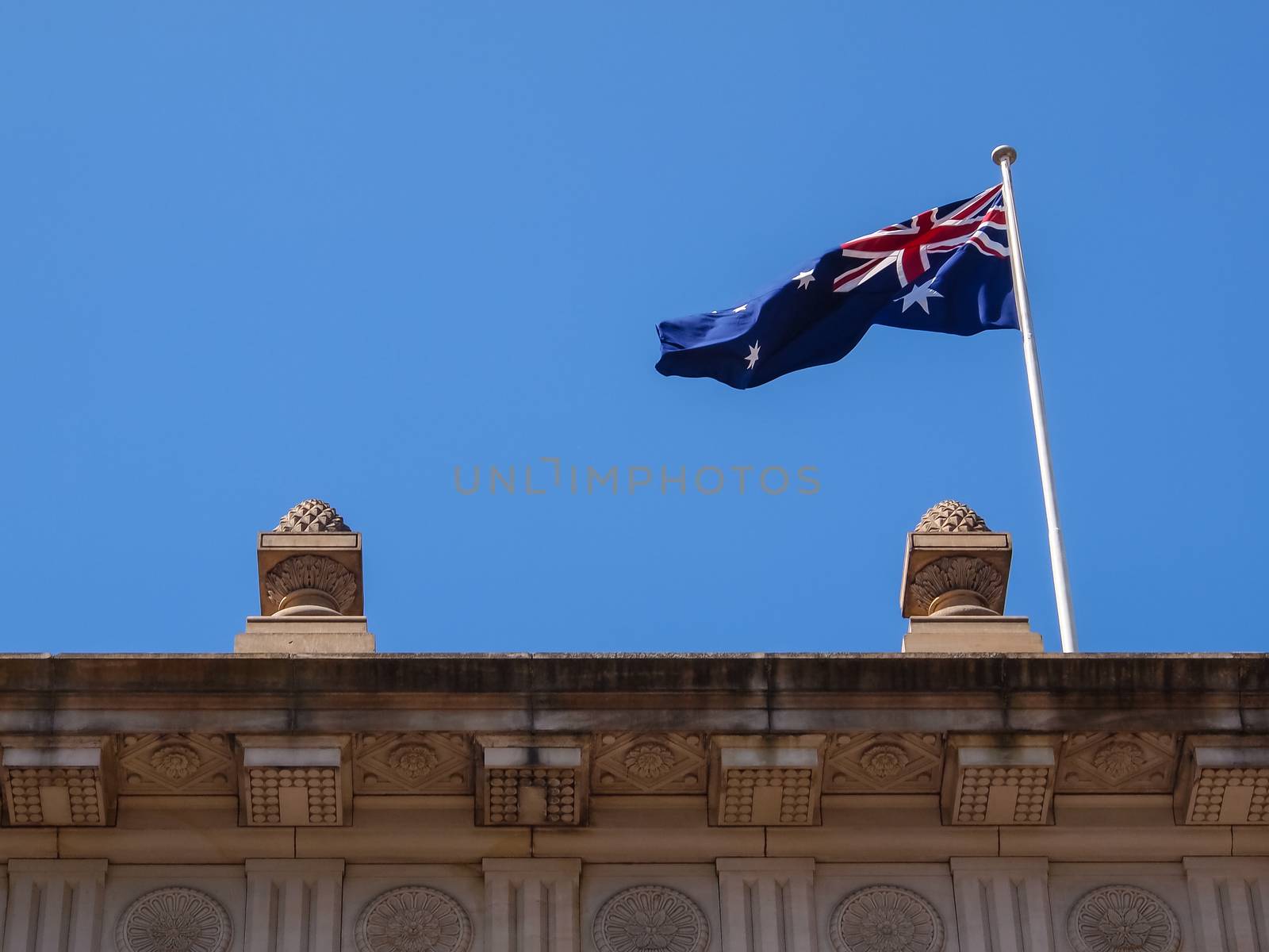 Australian flag on the top of building with blue sky