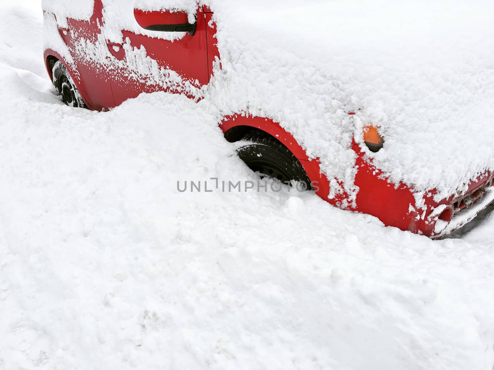 Red car in white snow. Montreal, Canada, after a snowstorm.