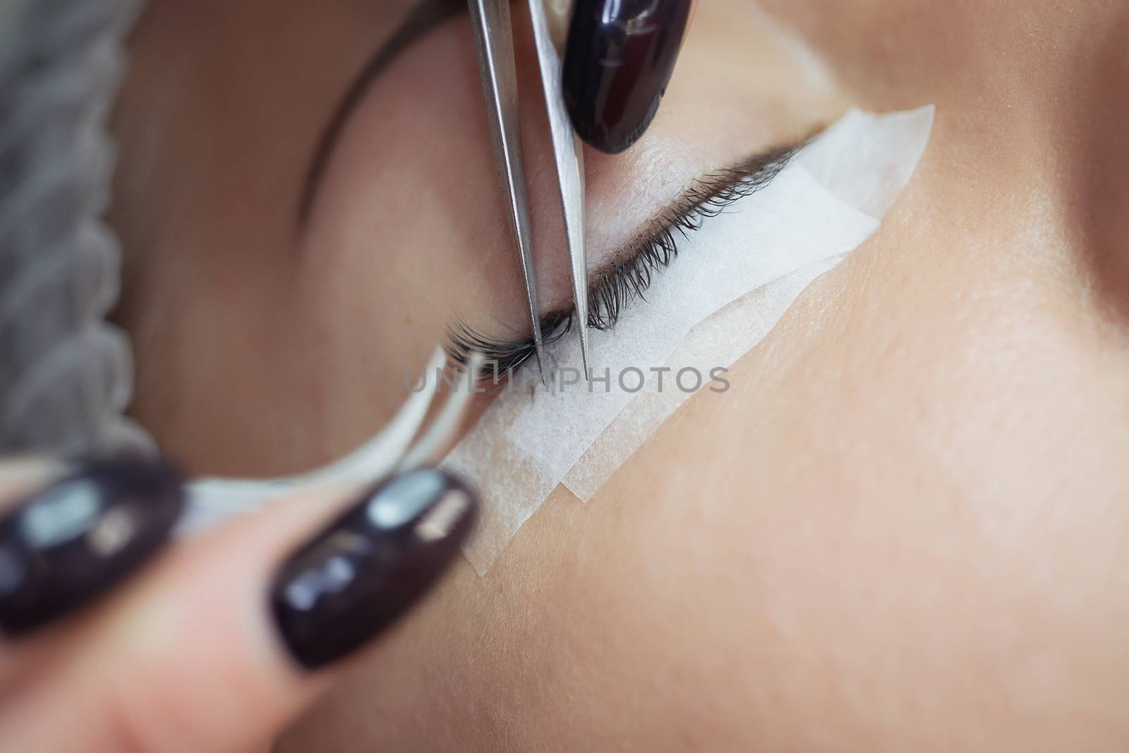 Eyelash Extension Procedure. Woman Eye with Long Eyelashes. Lashes, close up, macro, selective focus