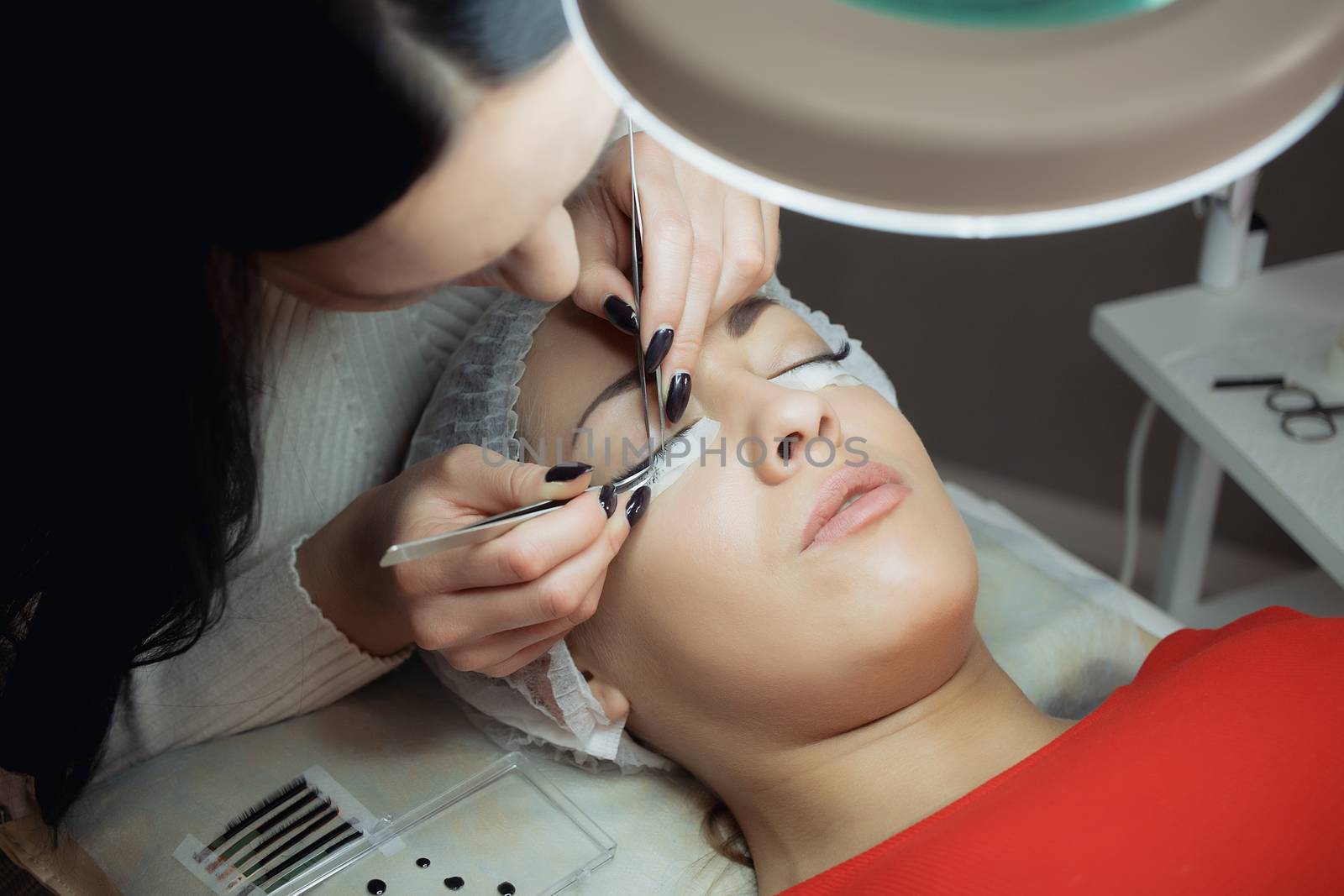 Eyelash Extension Procedure. Woman Eye with Long Eyelashes. by 3KStudio