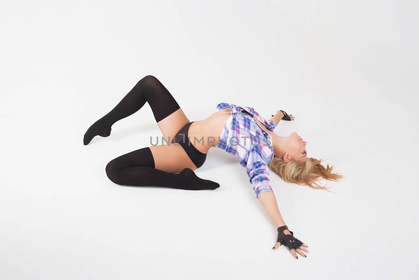 Blonde girl in stockings lying on the floor on white background by 3KStudio