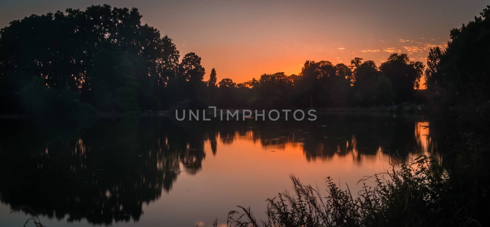 Vincennes park and lake close to Paris at dusk