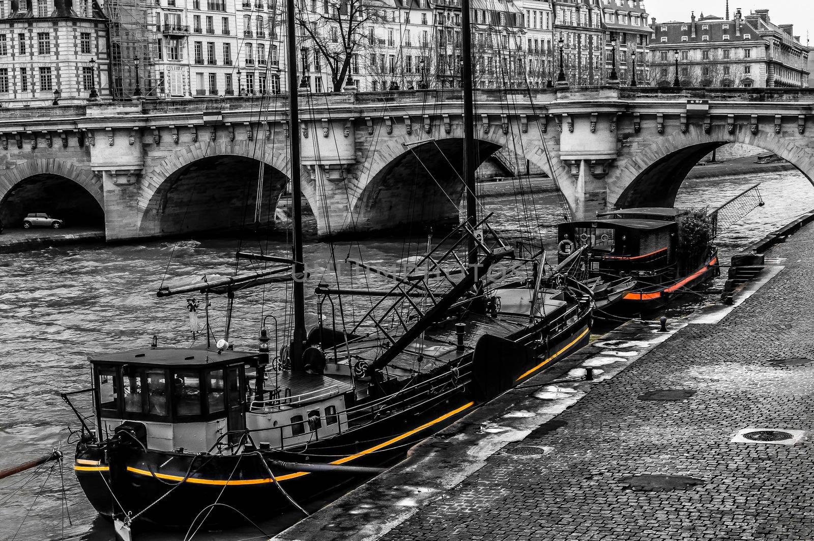 Black and white old boats on a Paris wharf