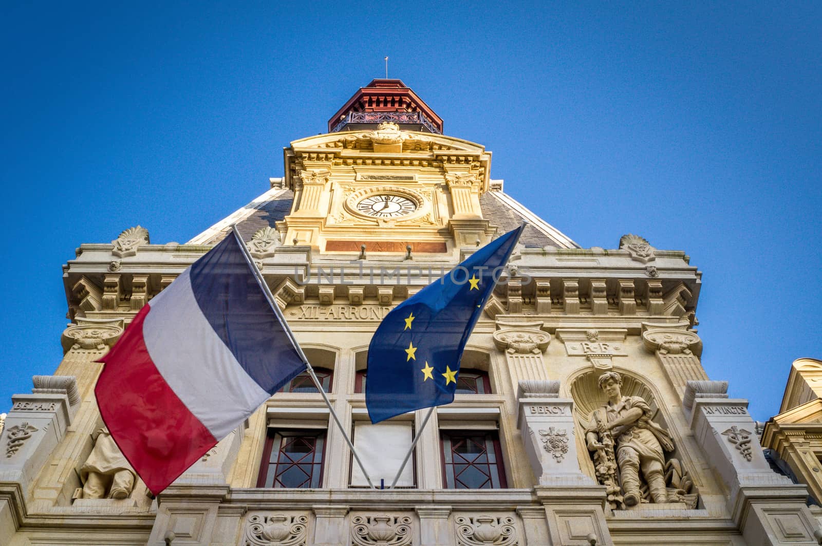 French and european flag on building of the city hall in the 12th arrondissement of Paris