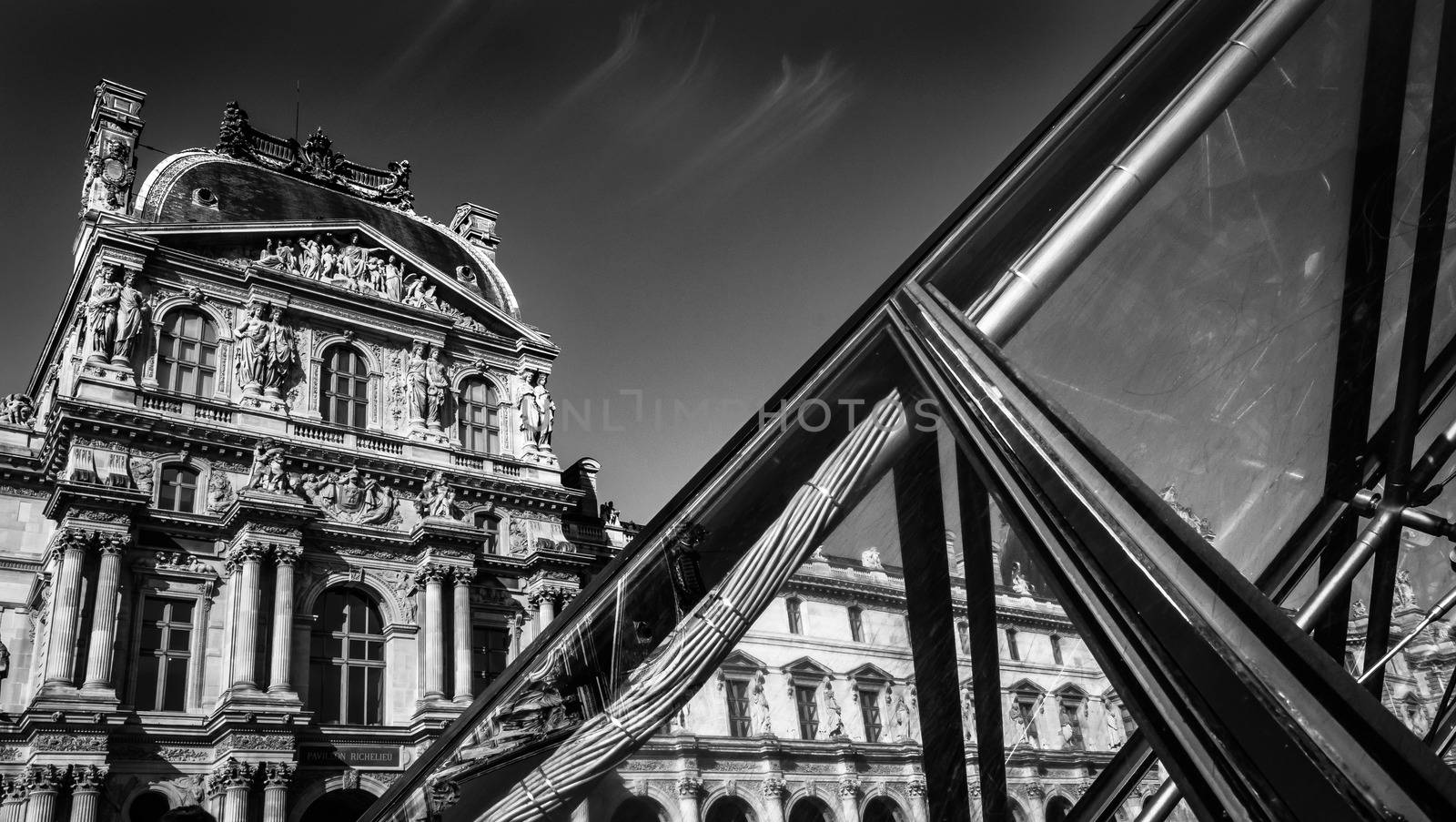 Black and white picture of the Louvre in Paris, metaphor of the modern and ancient