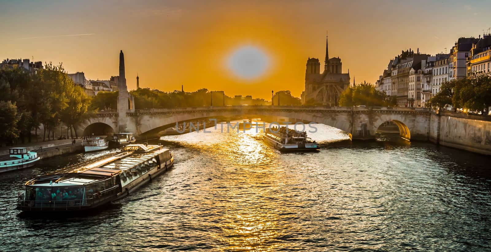Sunset over Paris bridge and Notre-dame in the summer