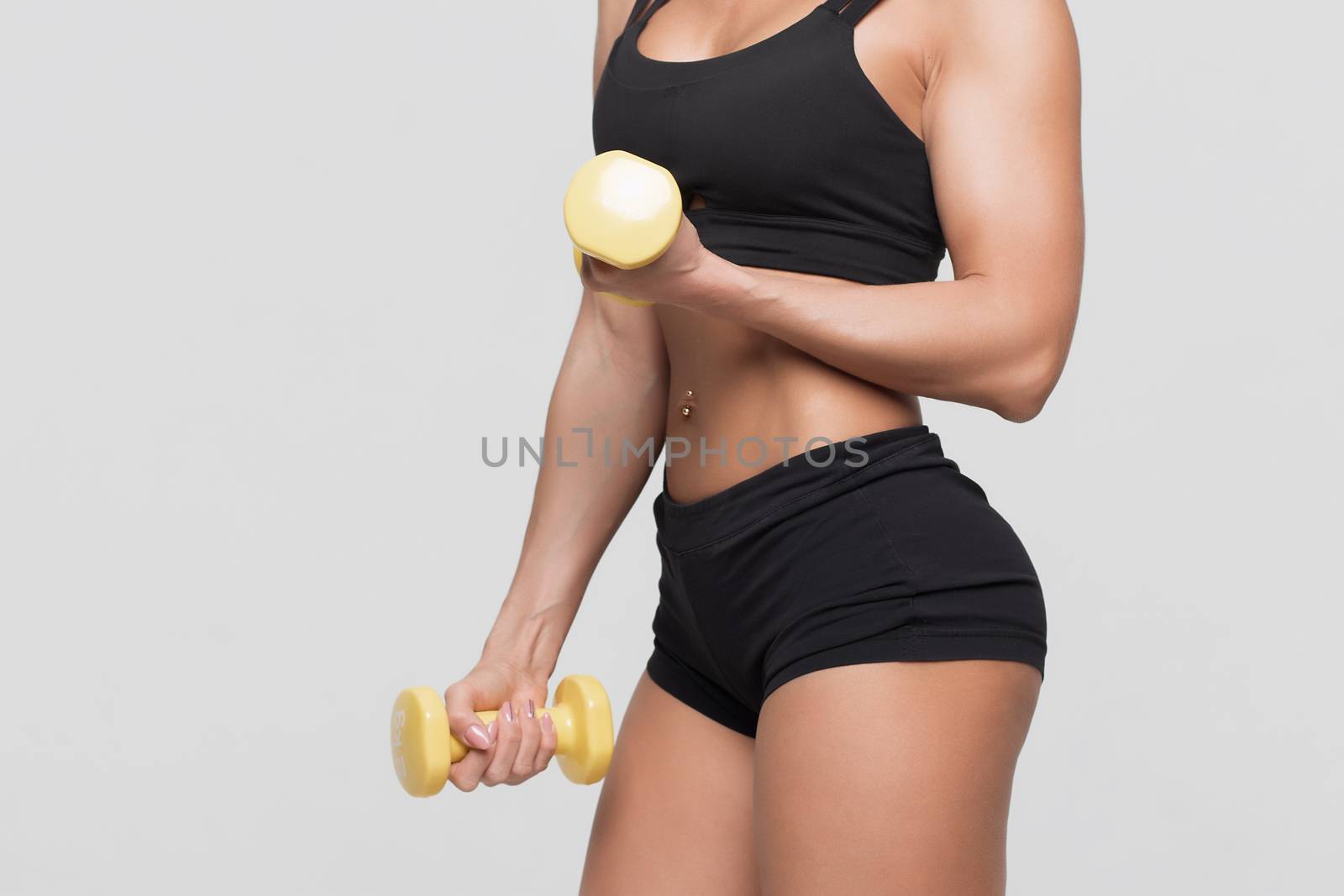 Fitness woman with barbells on grey background by 3KStudio