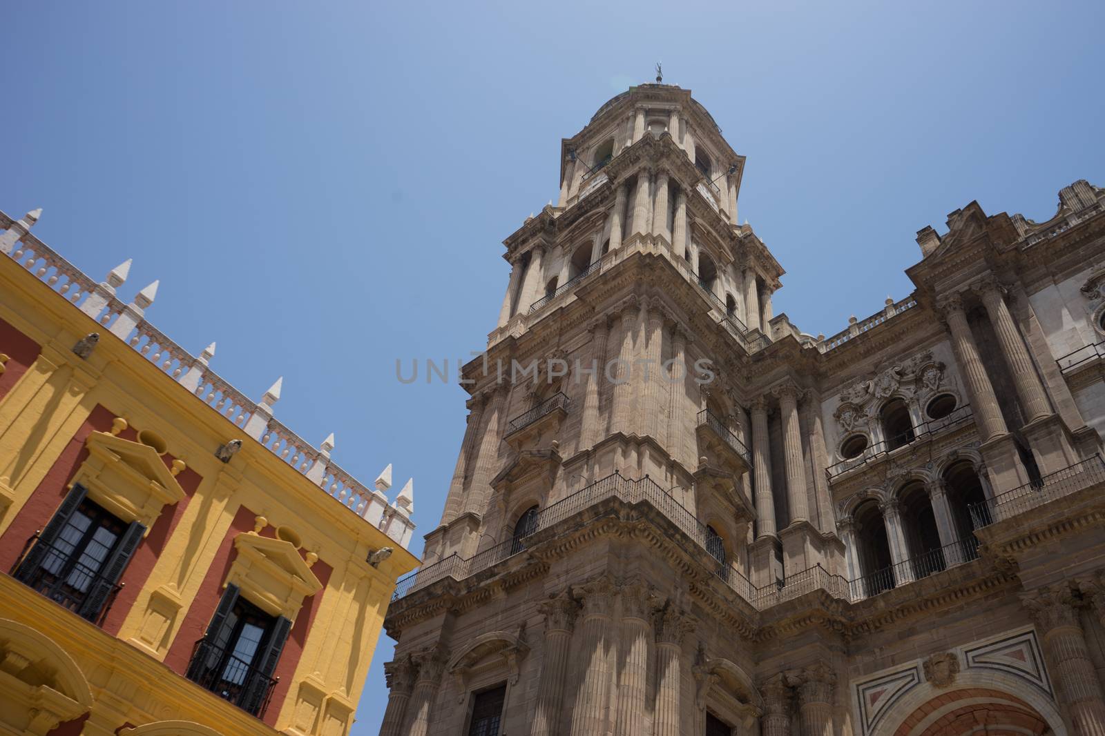 Cathedral Square and the episcopal palace in Malaga, Spain, Europe on a bright summer day with clear blue skies