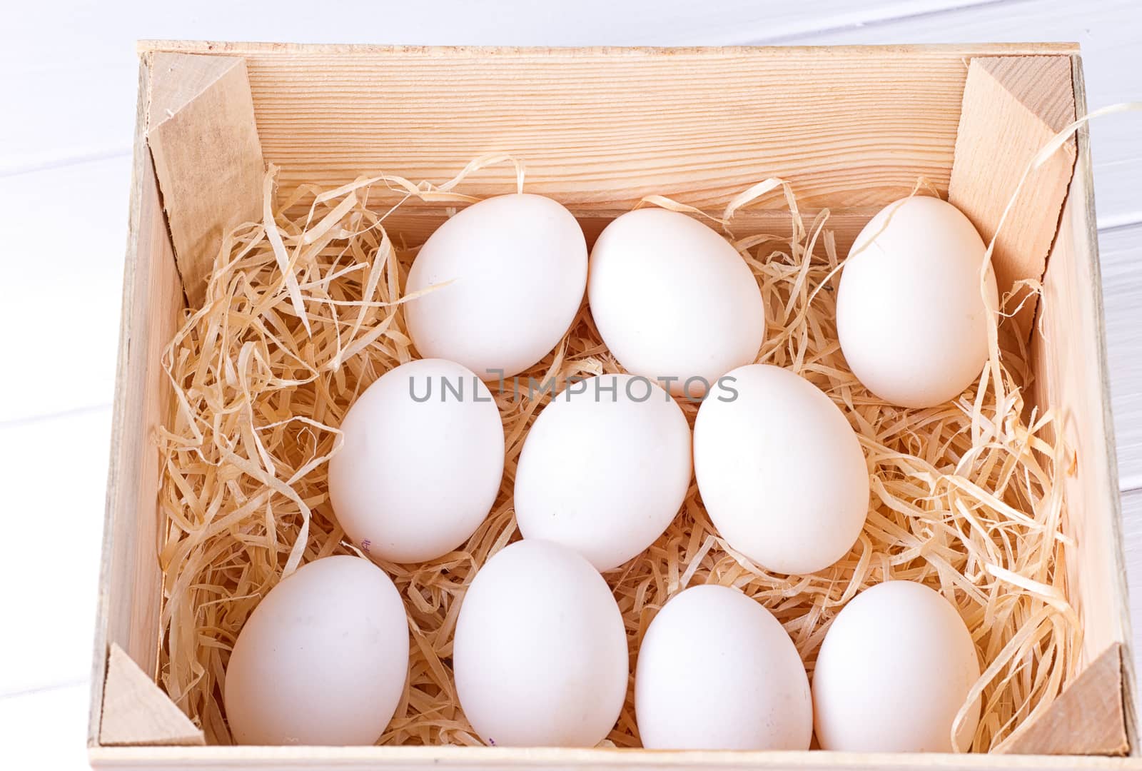 EA dozen white eggs in a wooden box