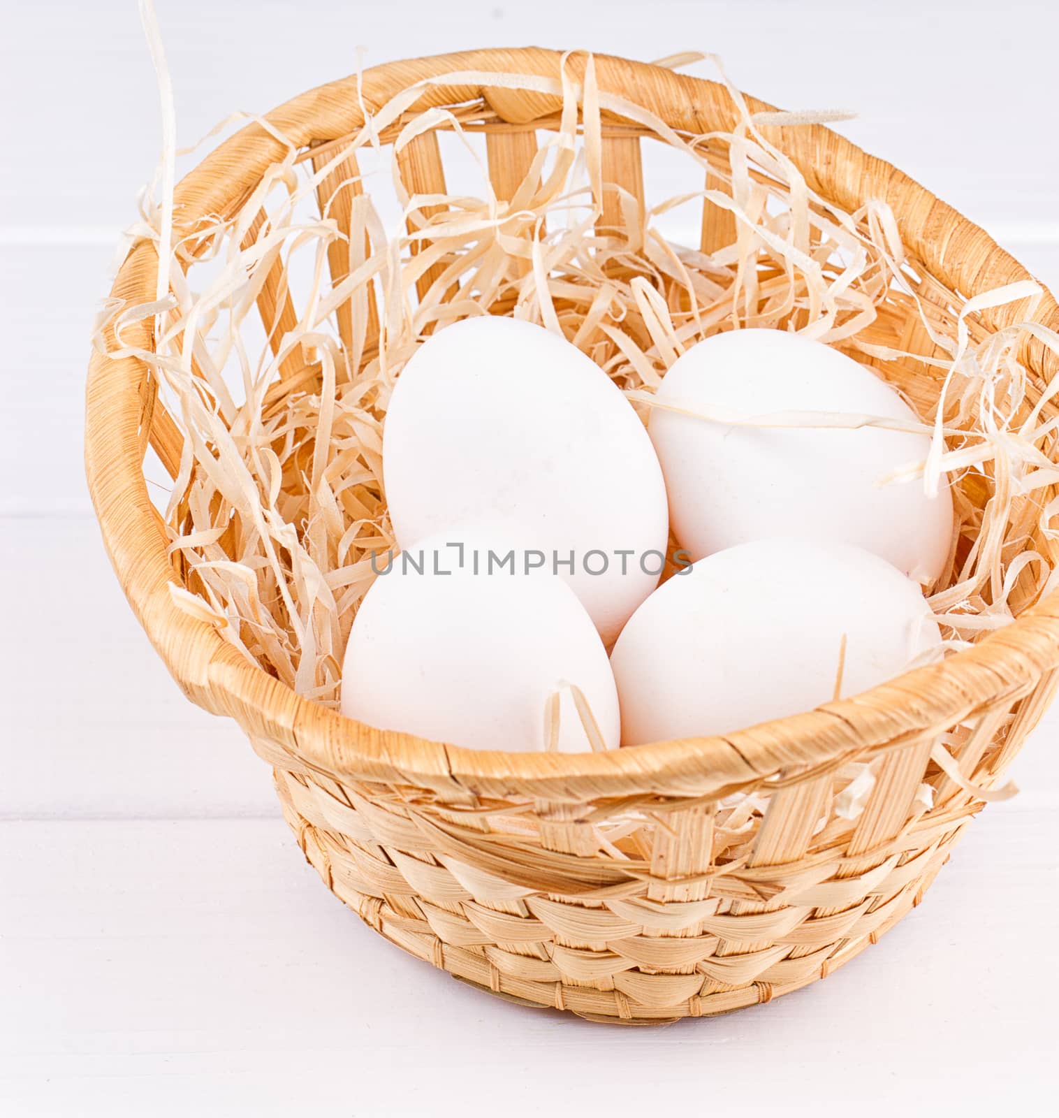 Eggs in basket on the white background