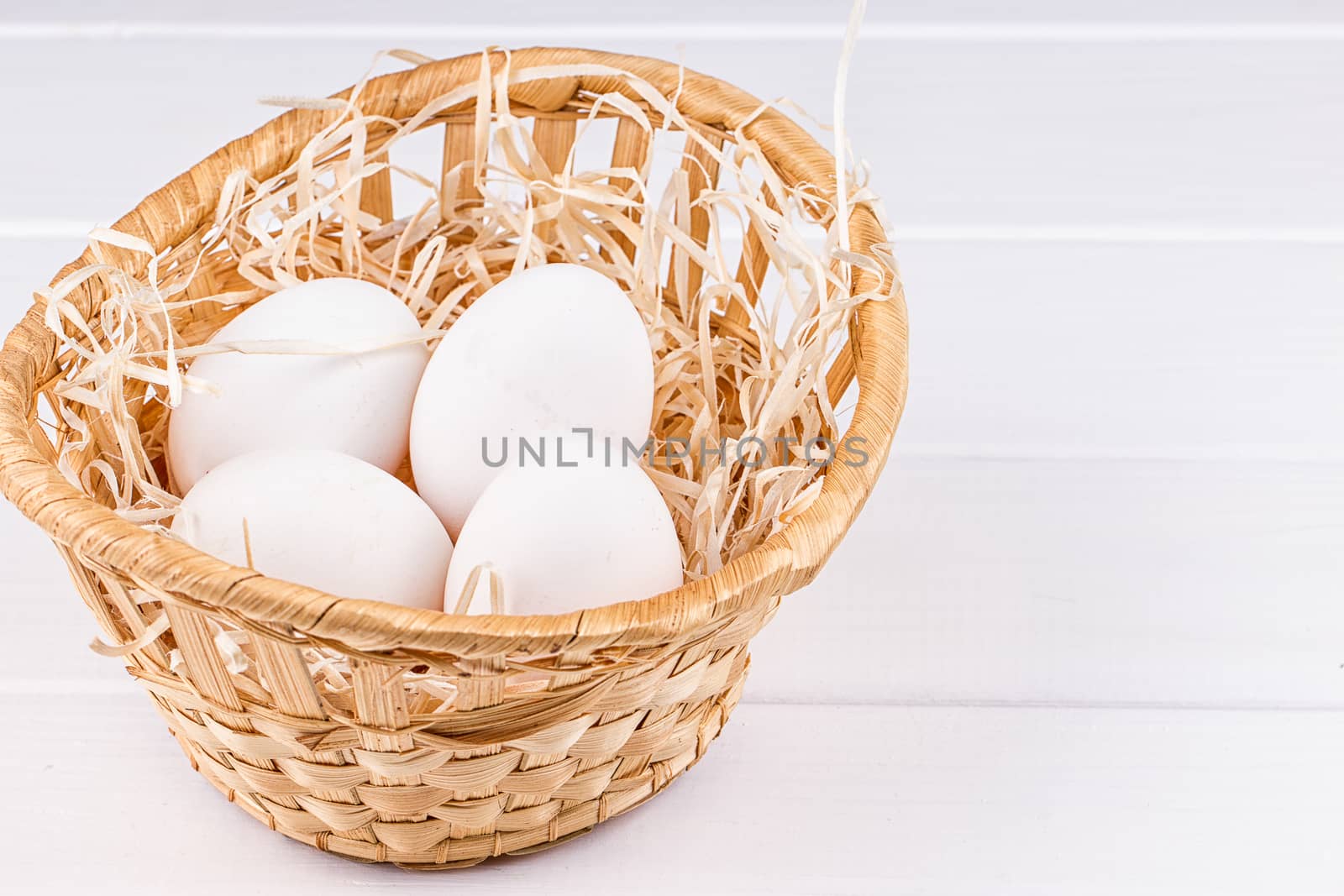 Eggs in basket on the white background