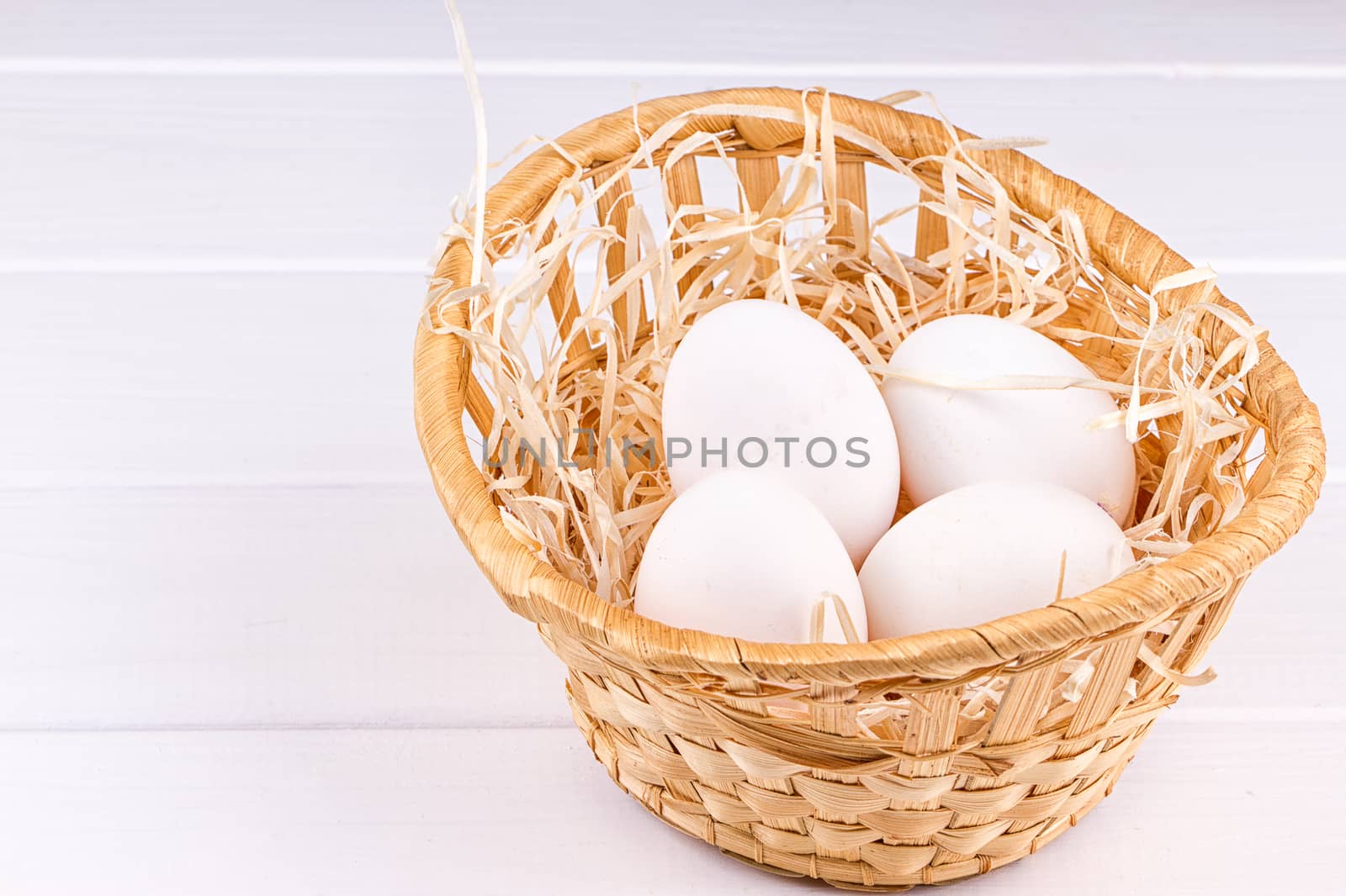 Eggs in basket on the white background