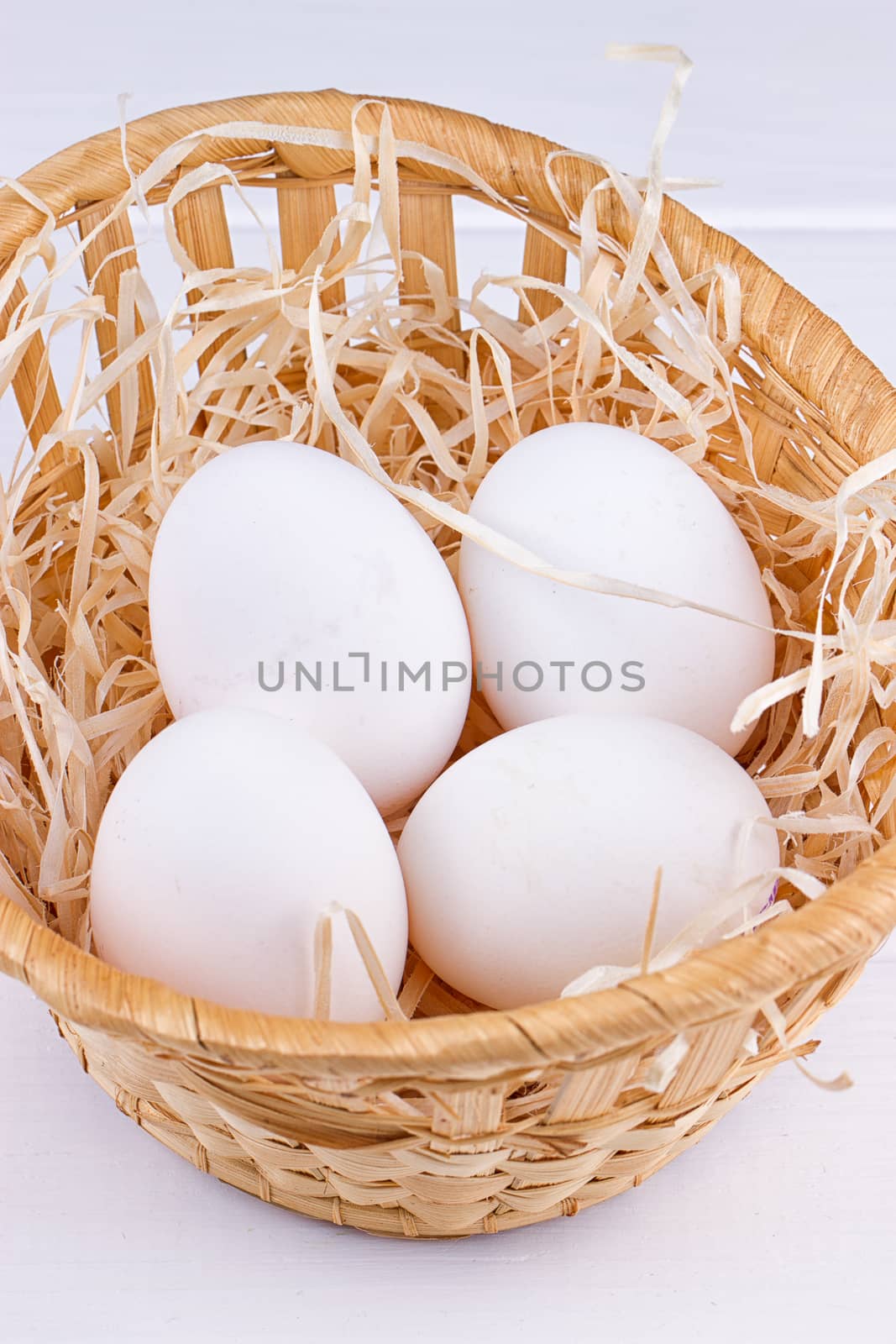 Eggs in basket on the white background