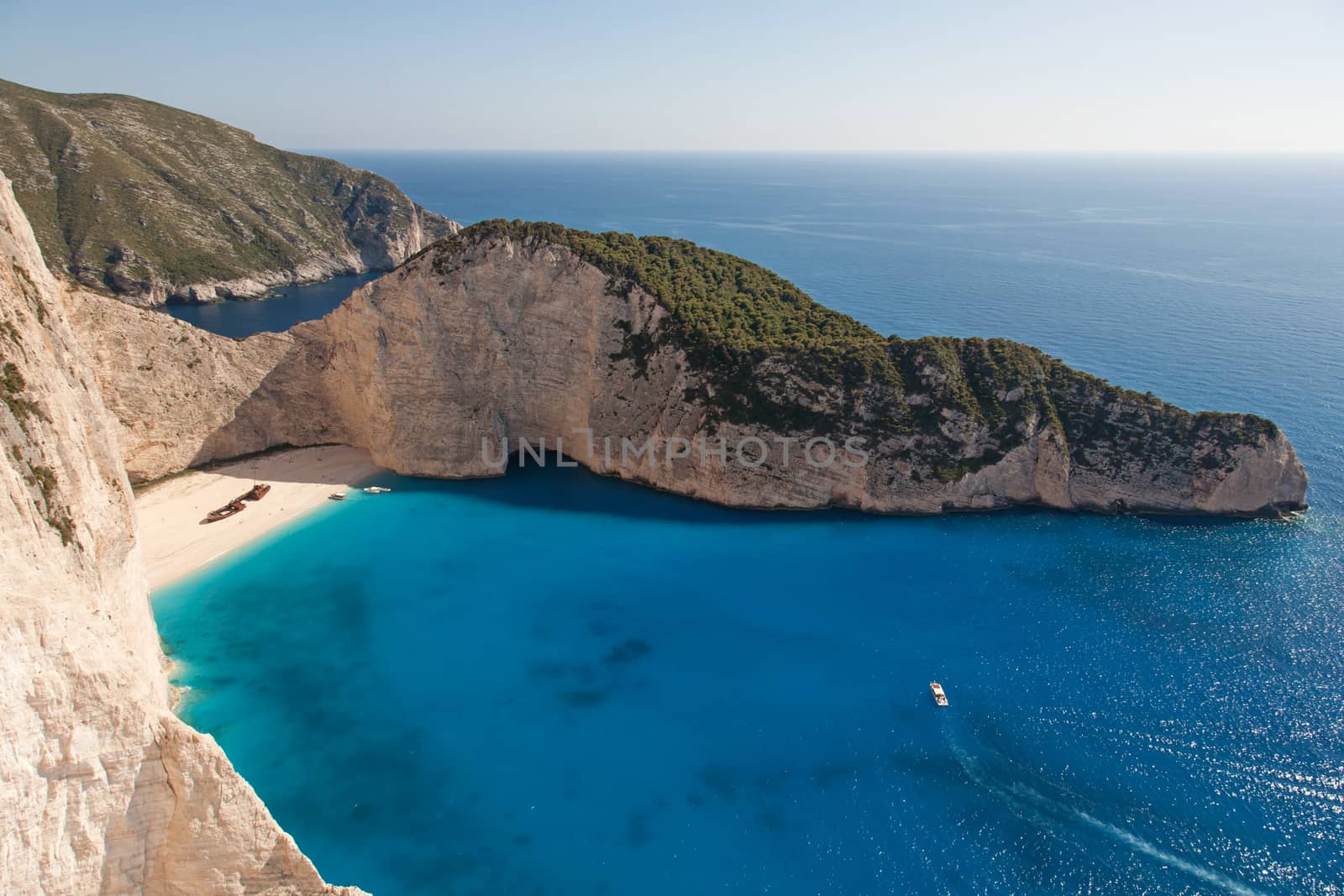 beautiful white beach with shipwreck in a greek island