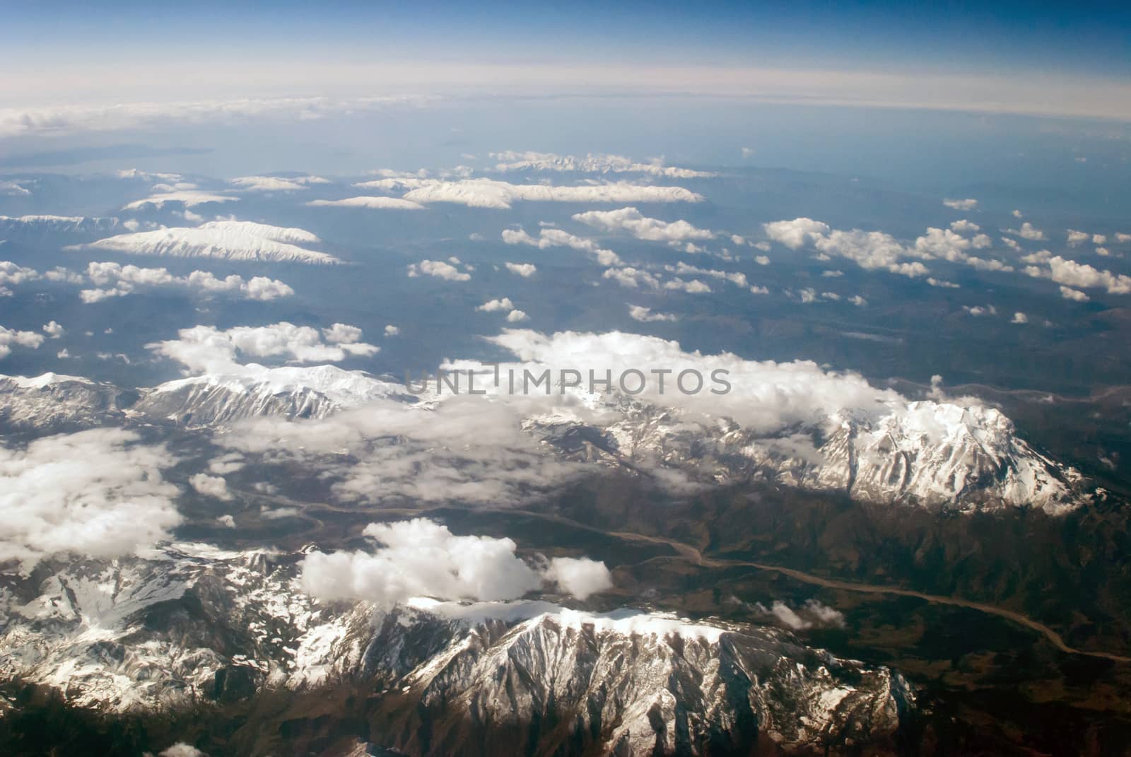 aerial view of mountains and clouds on top 