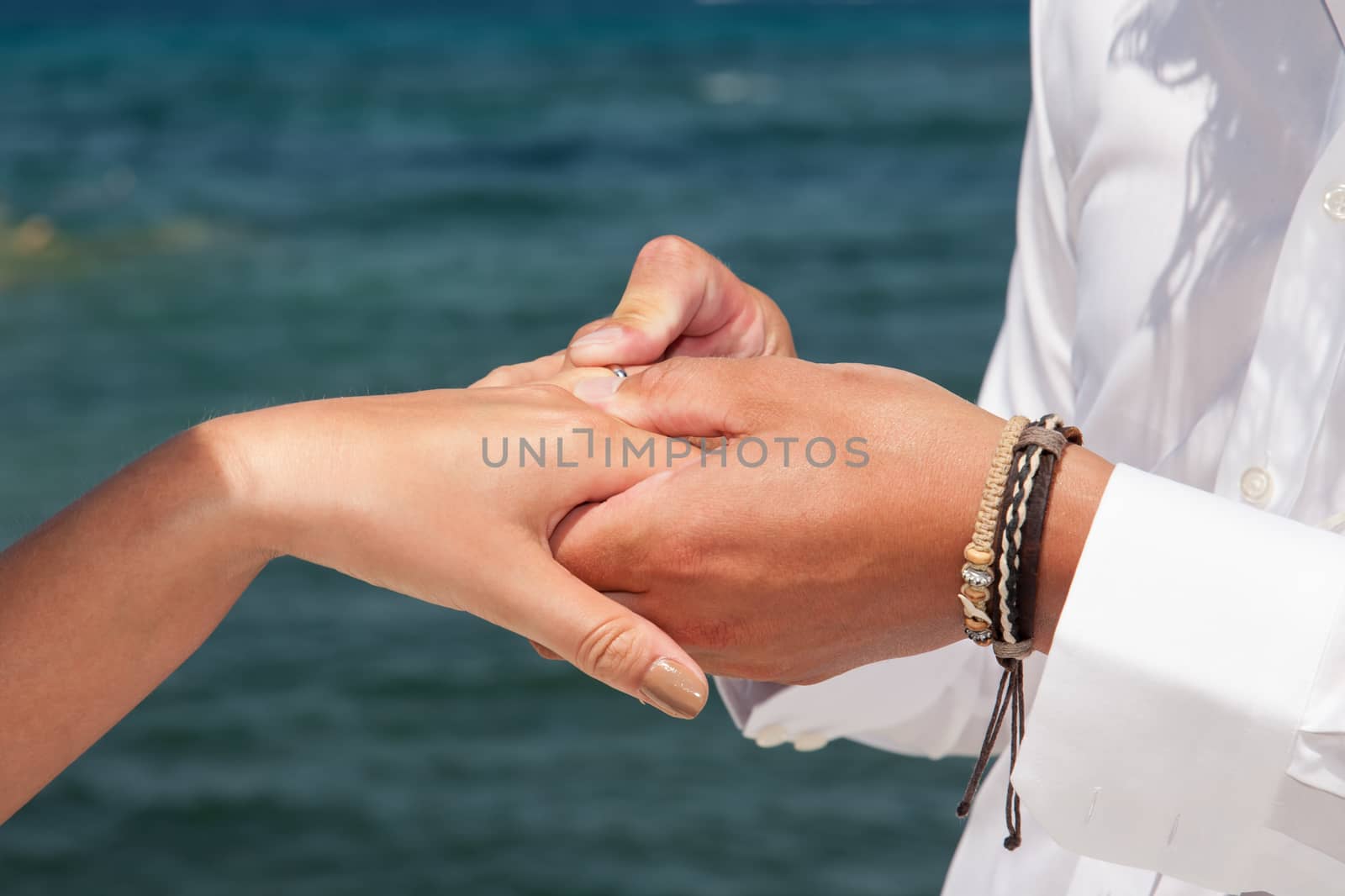 hands of couple with wedding rings by smoxx