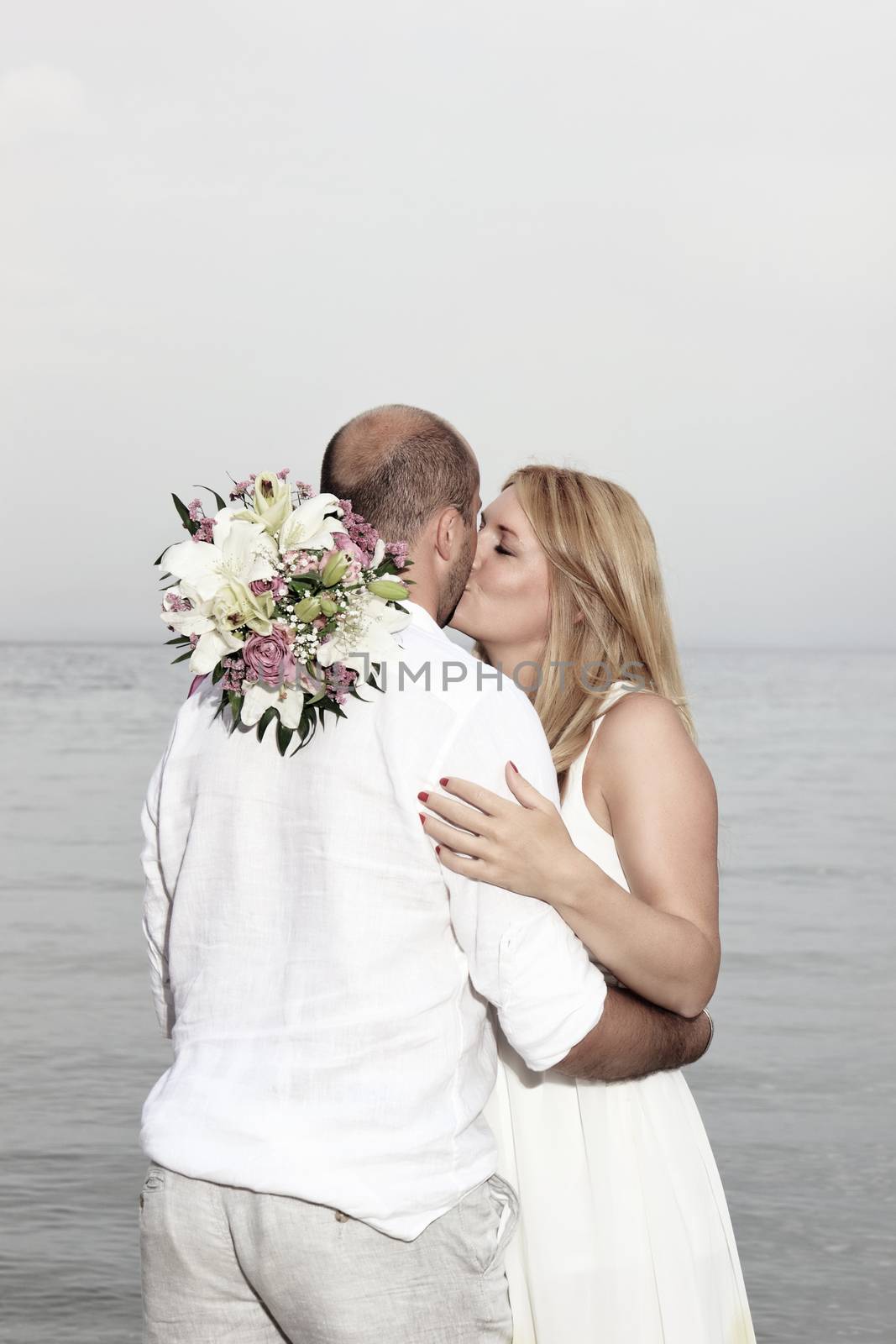 portrait of a young couple at the beach having romance
