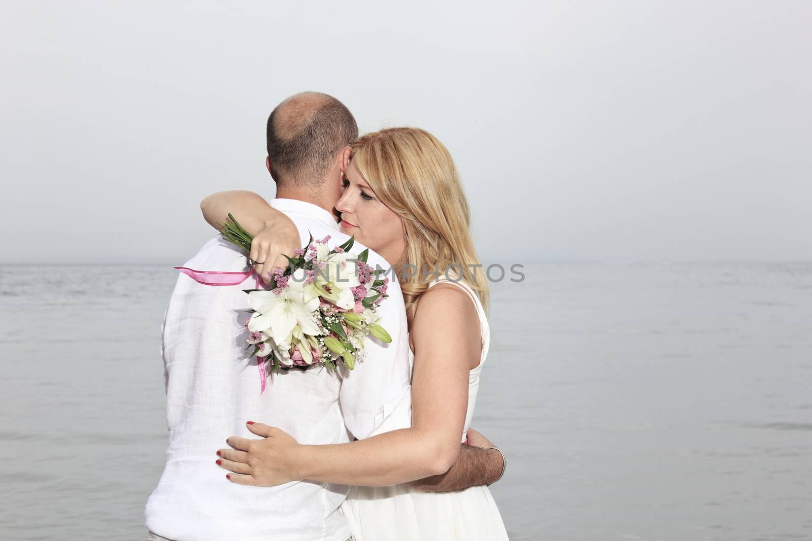 portrait of a young couple at the beach having romance
