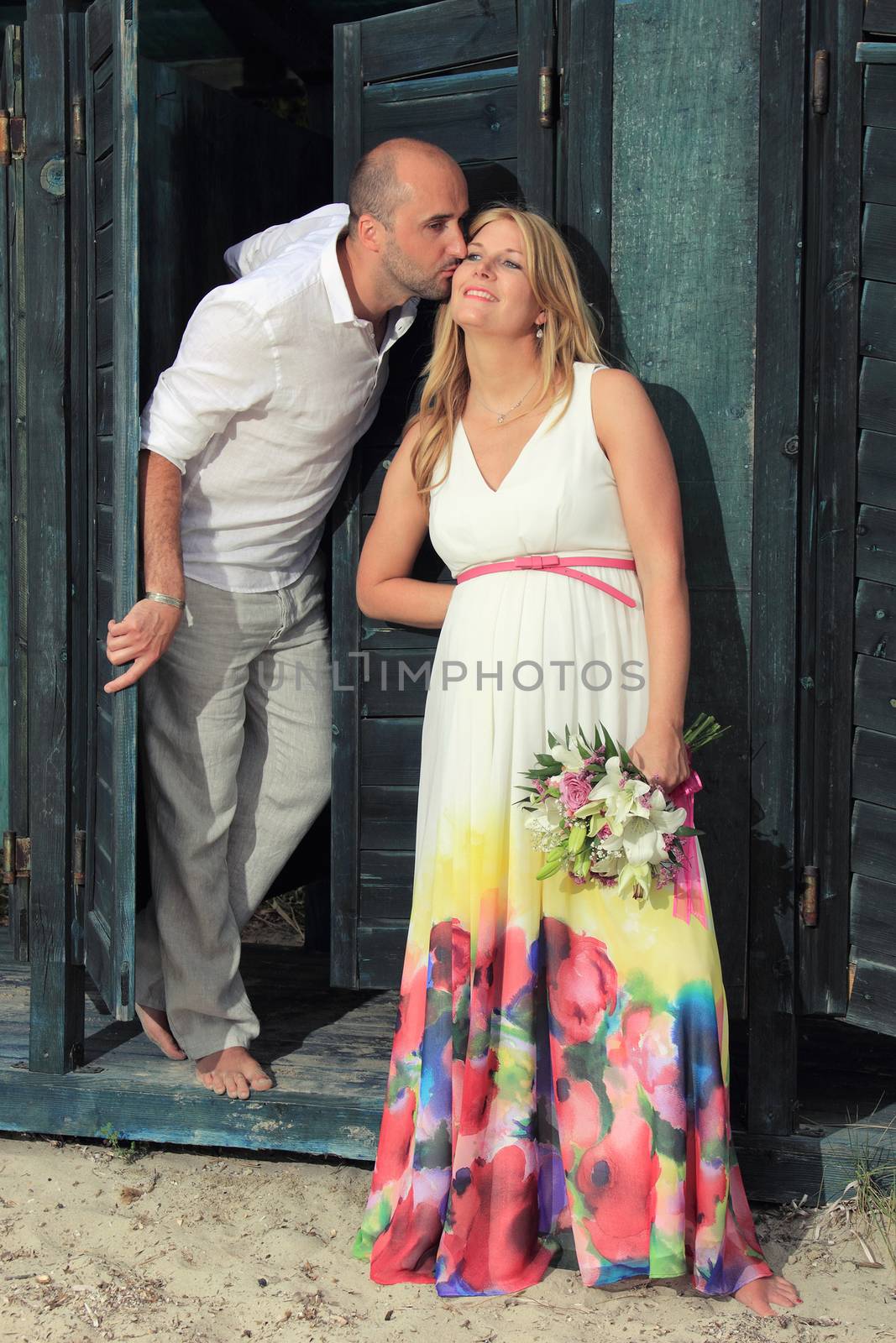 portrait of a young couple at the beach having romance
