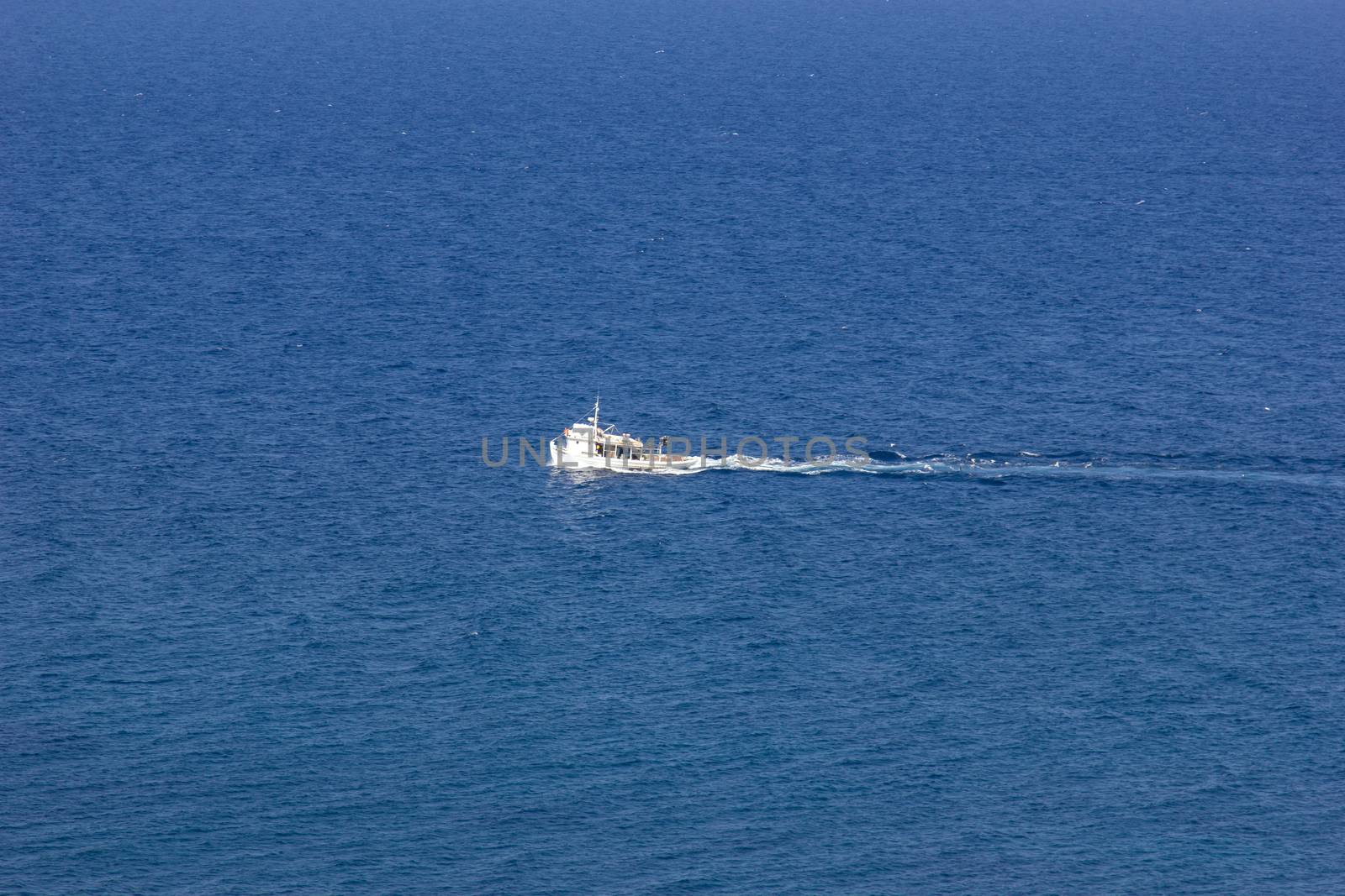 fishing boat traveling in the beautiful blue sea