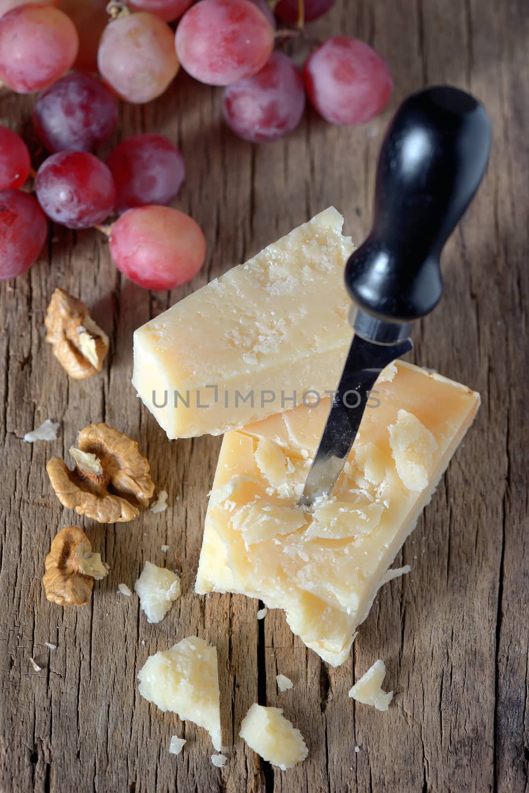 cheese, walnut, and grapes on wooden table
