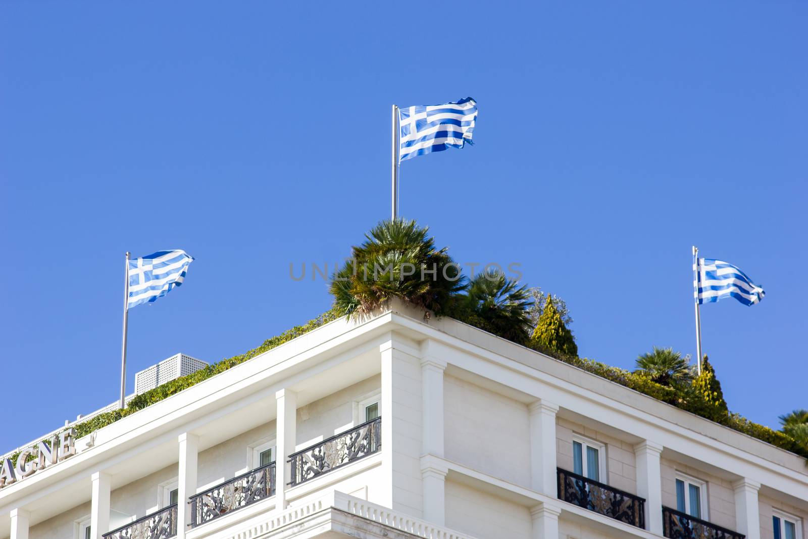 greek flags on the roof garden of a building